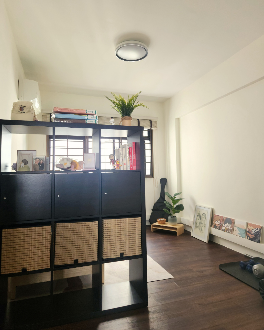 Personal Touches: Bringing Warmth to Our Guest Room - black cabinet, black shelving, indoor plants, framed pictures, white
