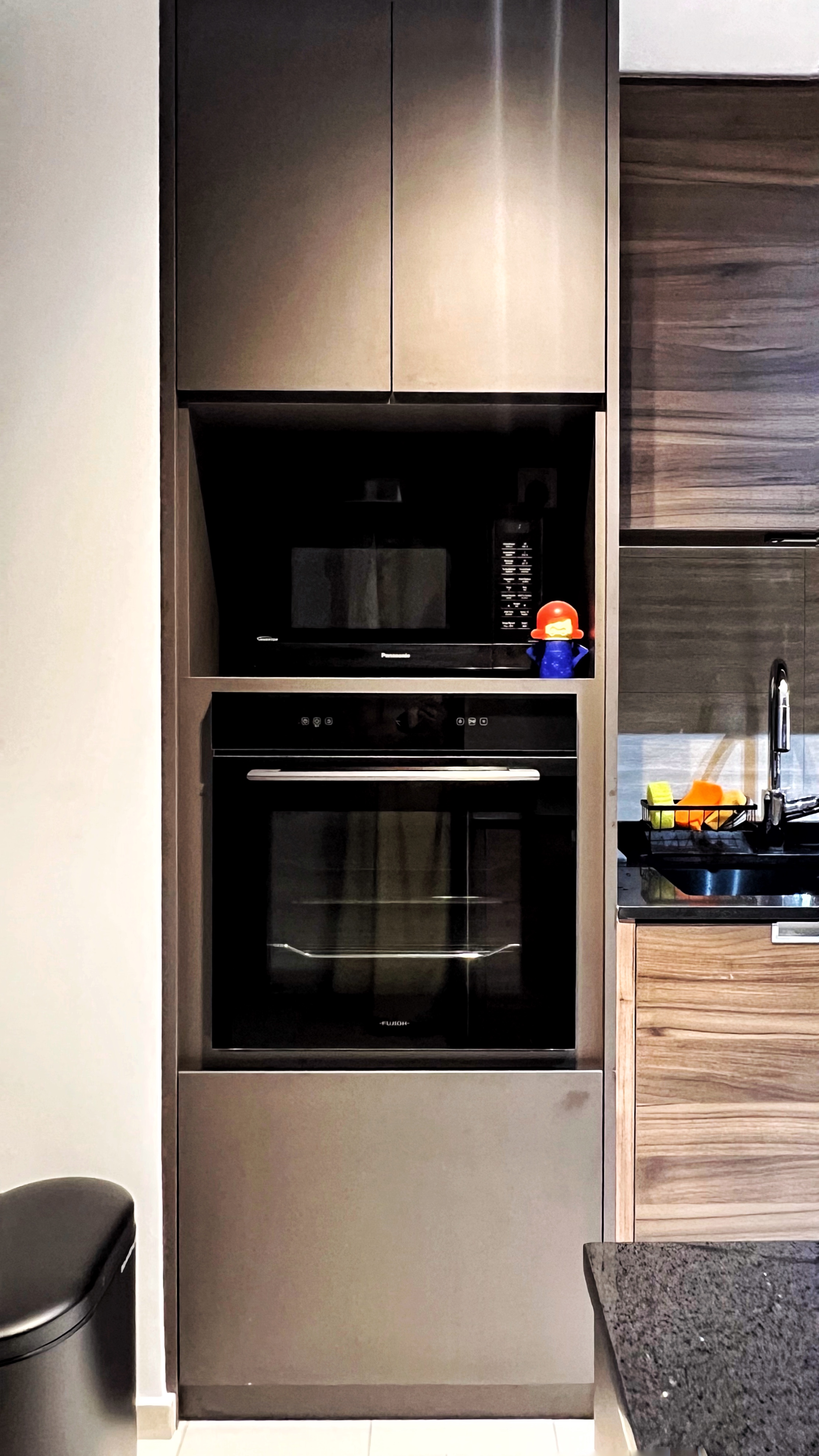 Cooking is an Adventure and This is My Launchpad! - Modern kitchen with sleek stainless steel appliances, built-in oven and