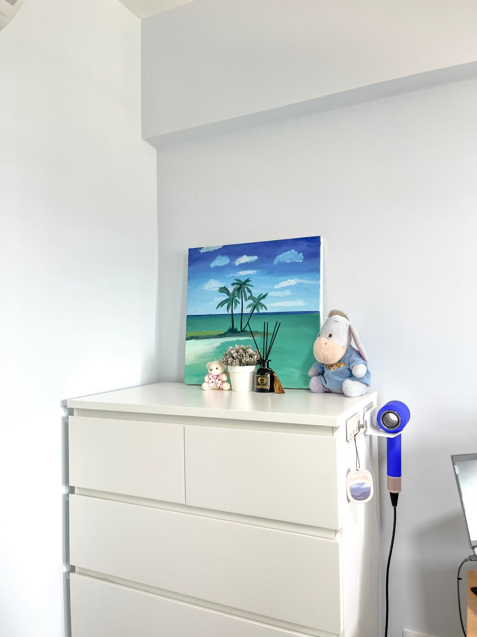 Home Office: White vs Black - White dresser, minimalist decor, beach painting, palm trees, blue sky, lily pads, ocean
