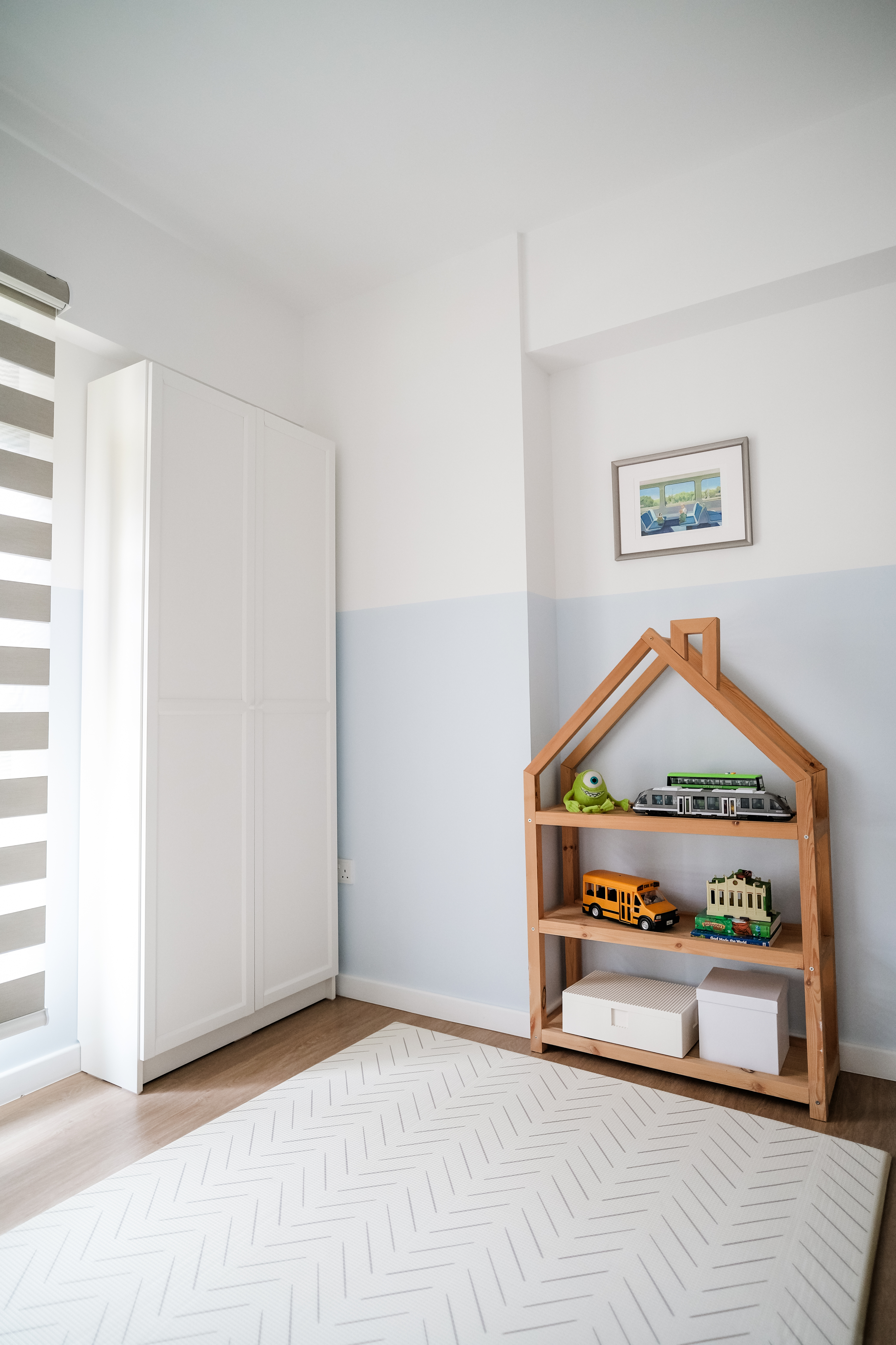 Playroom Design with Loose Furniture for Maximum Space and Flexibility - White wooden shelf, toy train, green monster, toy