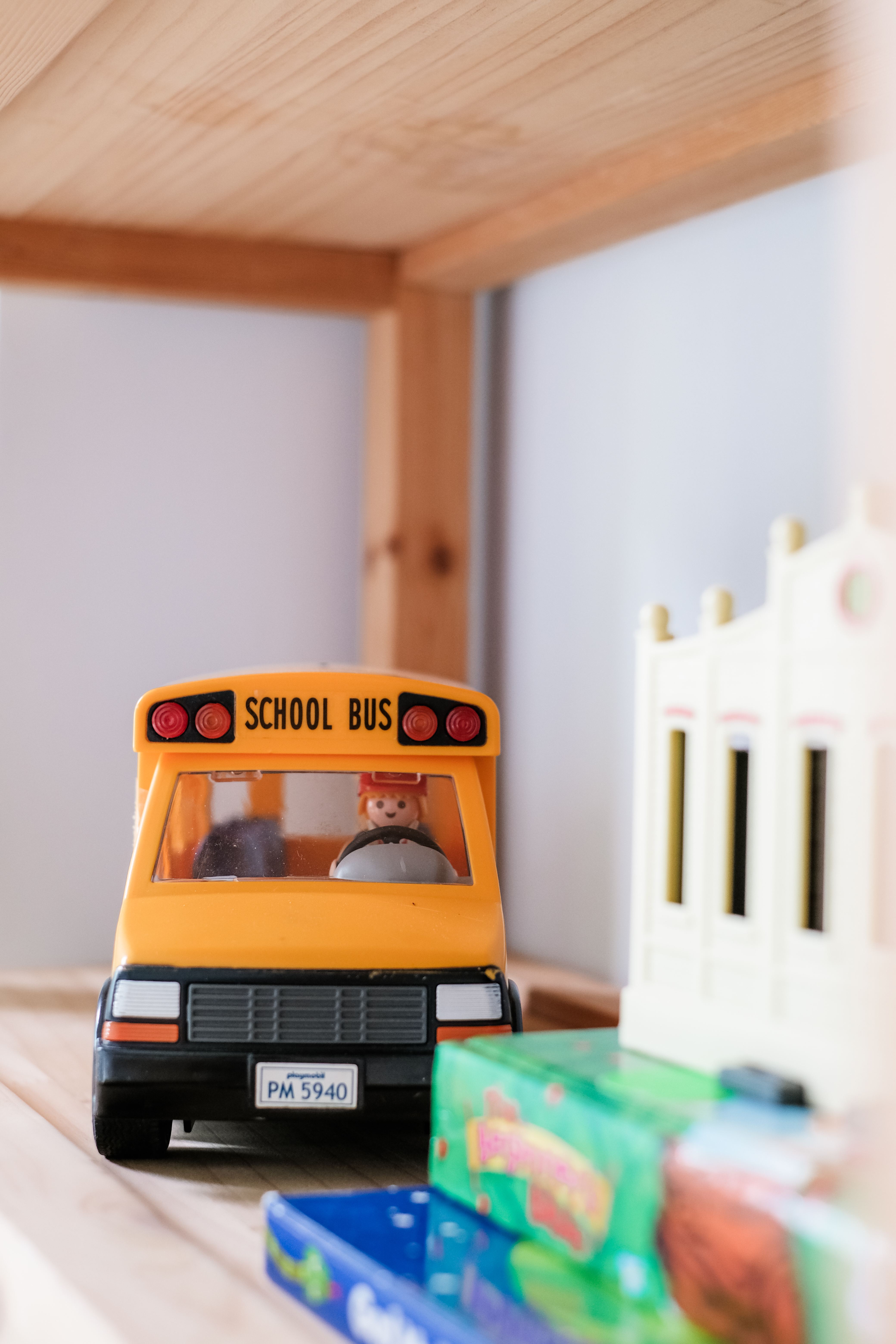 Playroom Design with Loose Furniture for Maximum Space and Flexibility - Yellow school bus with red lights, license plate "PM