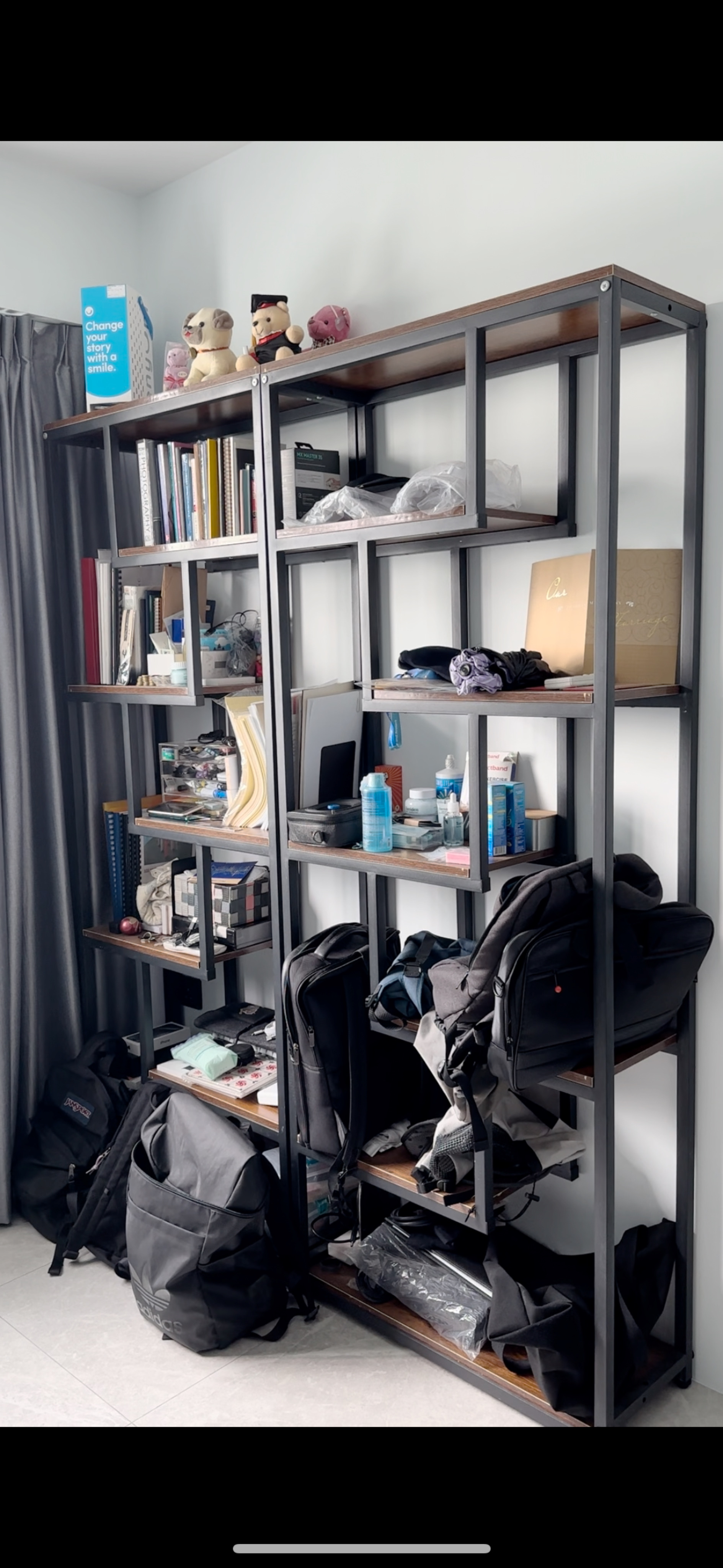 Ergonomic Home Office Setup! - Modern shelving unit with various items, including books, bags, and decorative objects.