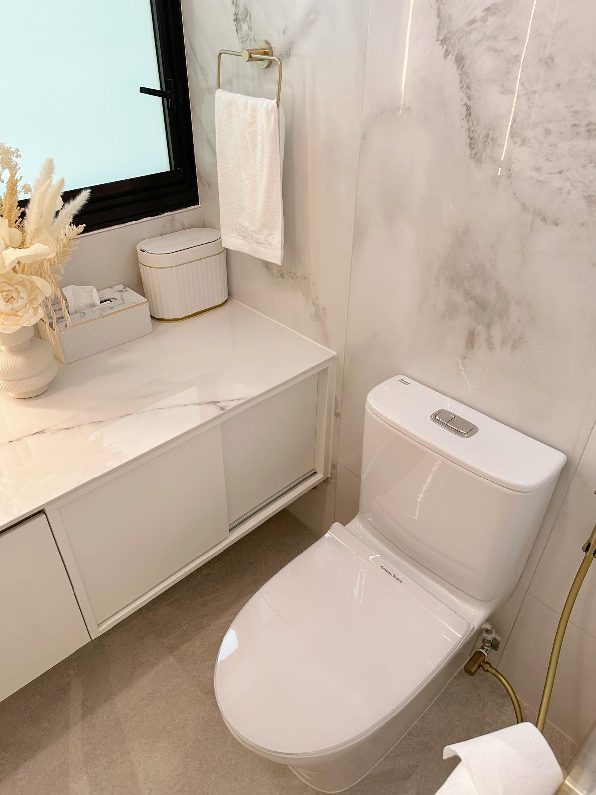 Guest bath: Marble, gold & sliding doors - White bathroom vanity, marble countertop, modern toilet, gold faucet, elegant