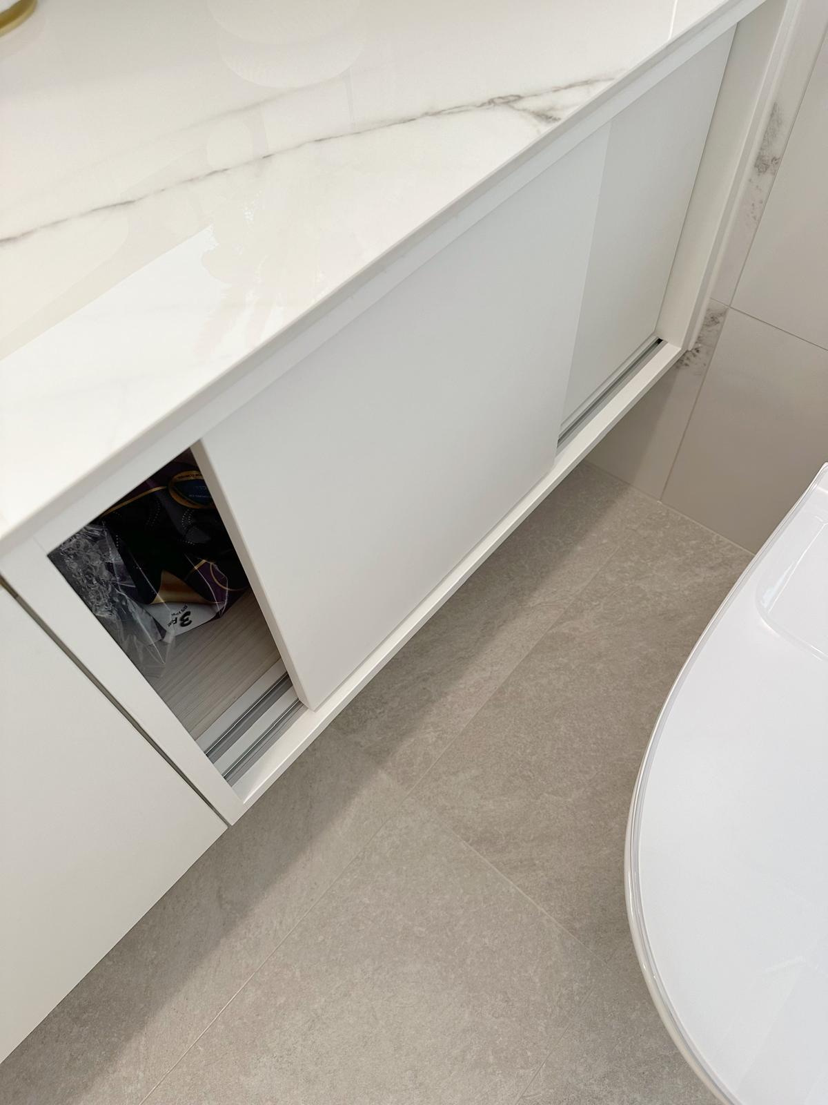 Guest bath: Marble, gold & sliding doors - White marble countertop, modern cabinetry, sleek design, minimalist bathroom
