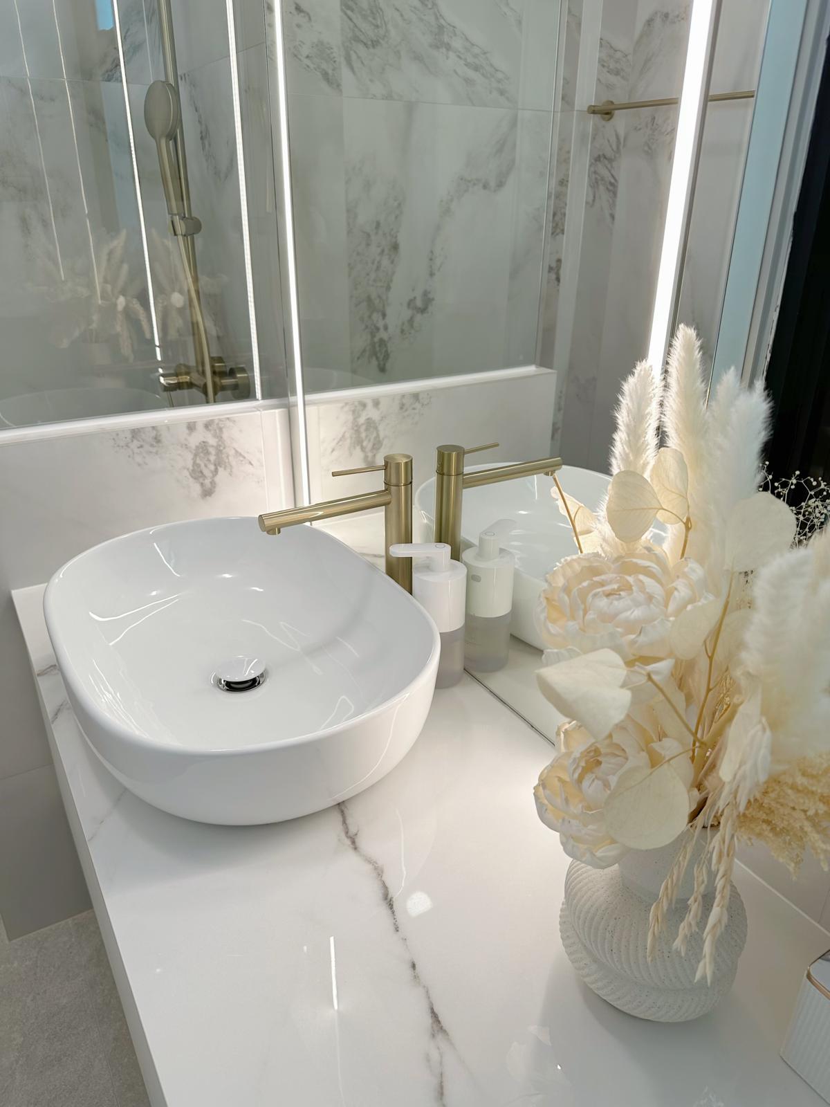 Guest bath: Marble, gold & sliding doors - White marble countertop, modern sink, gold fixtures, elegant bathroom, luxurious