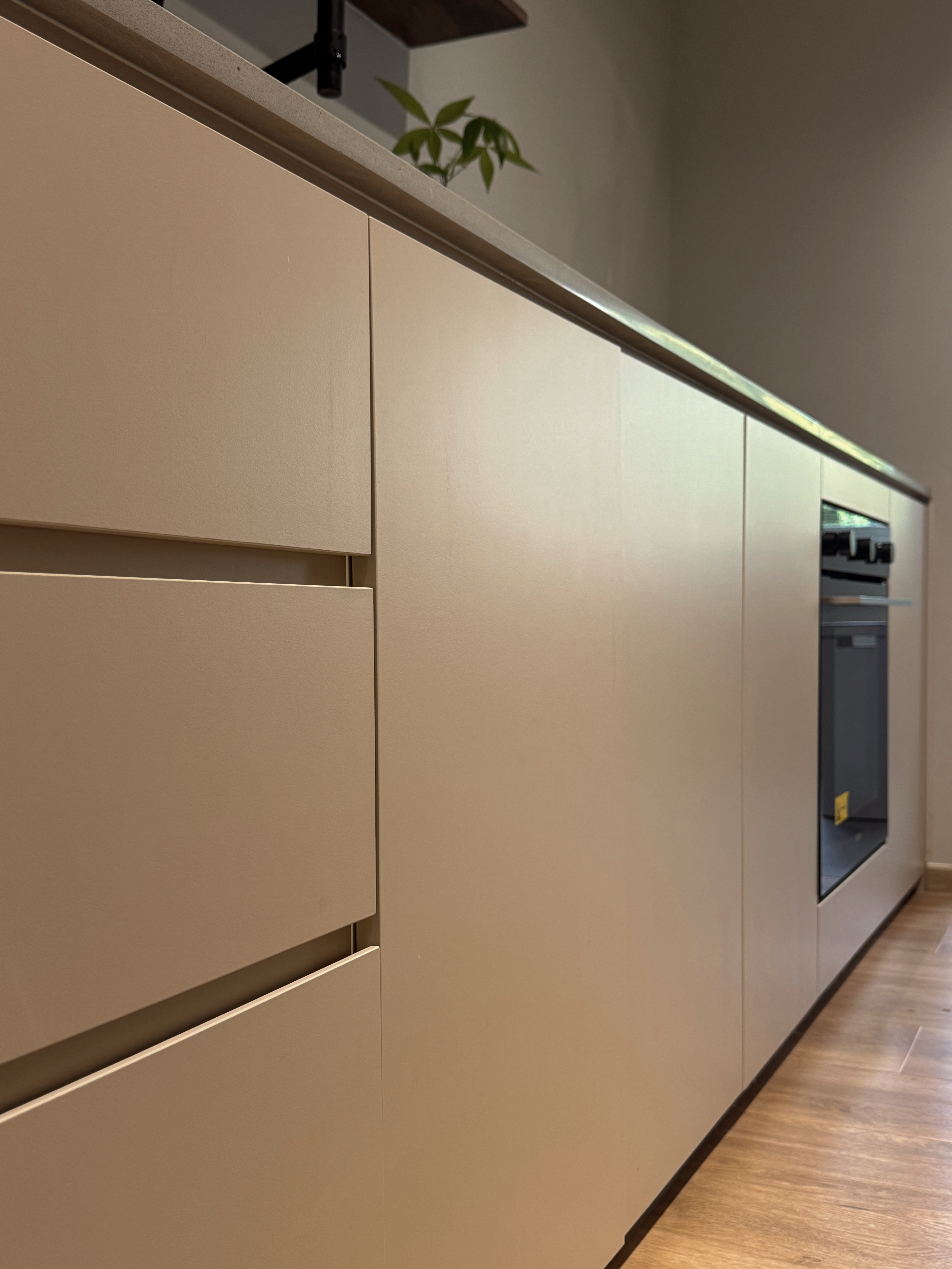 Our Kitchen Renovation Journey: FAQs and Lessons Learned - Cream-colored kitchen cabinets, sleek design, minimalist