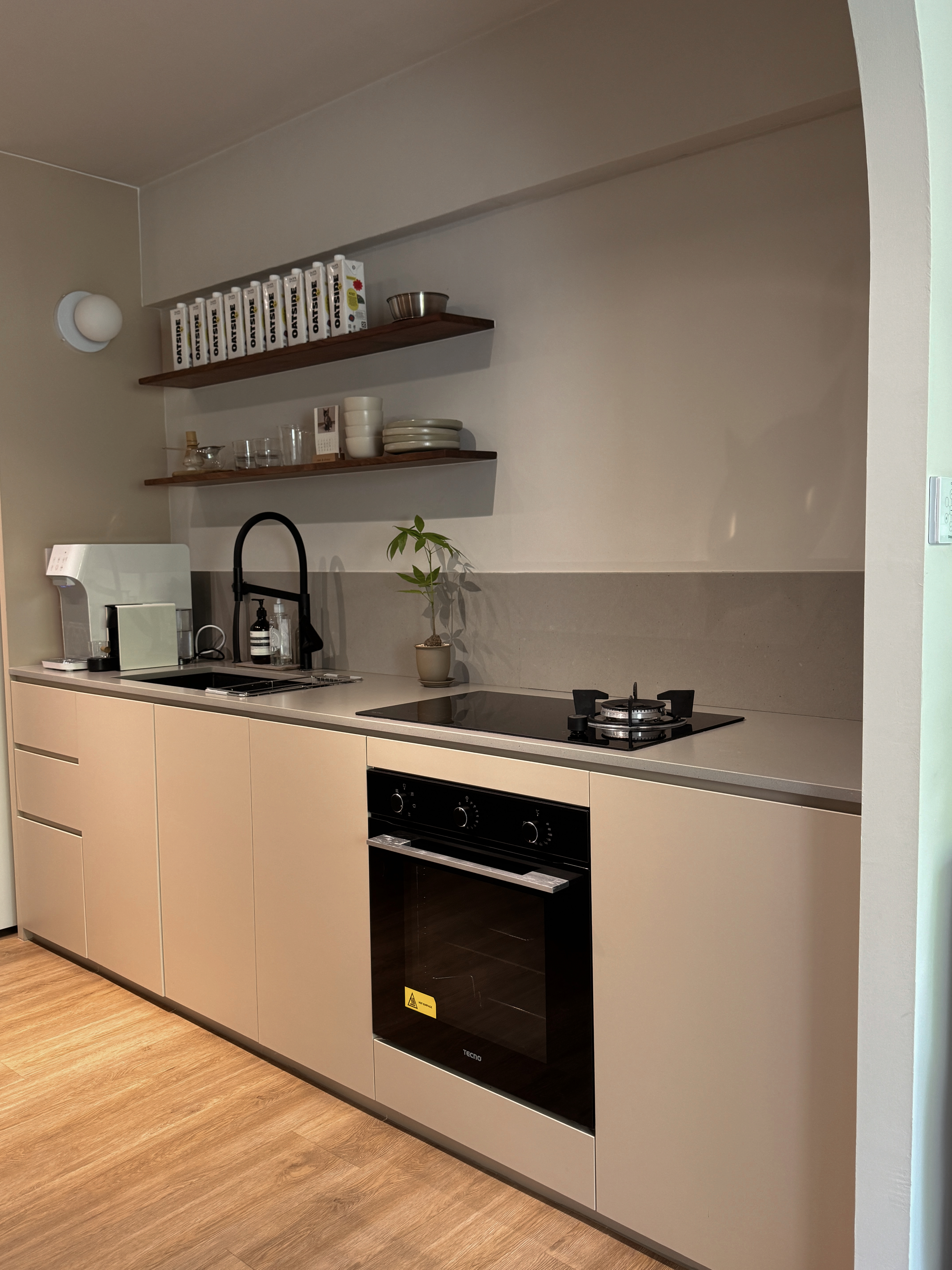 Our Kitchen Renovation Journey: FAQs and Lessons Learned - Modern kitchen with sleek design, beige cabinets, black oven