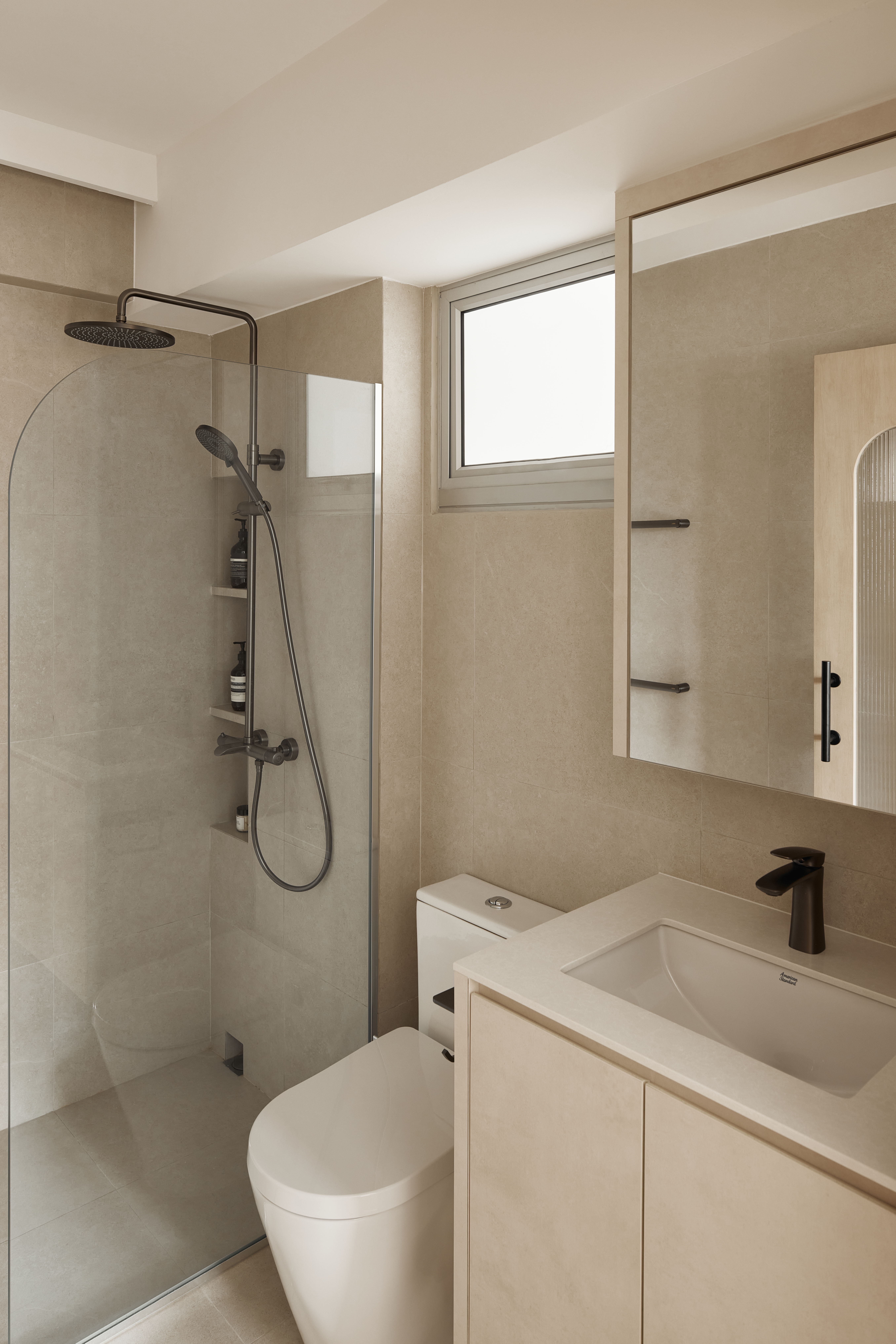 Master Bathroom: Our Most-Loved Space in the Entire Home - Modern bathroom with beige tiles, sleek shower with glass door and