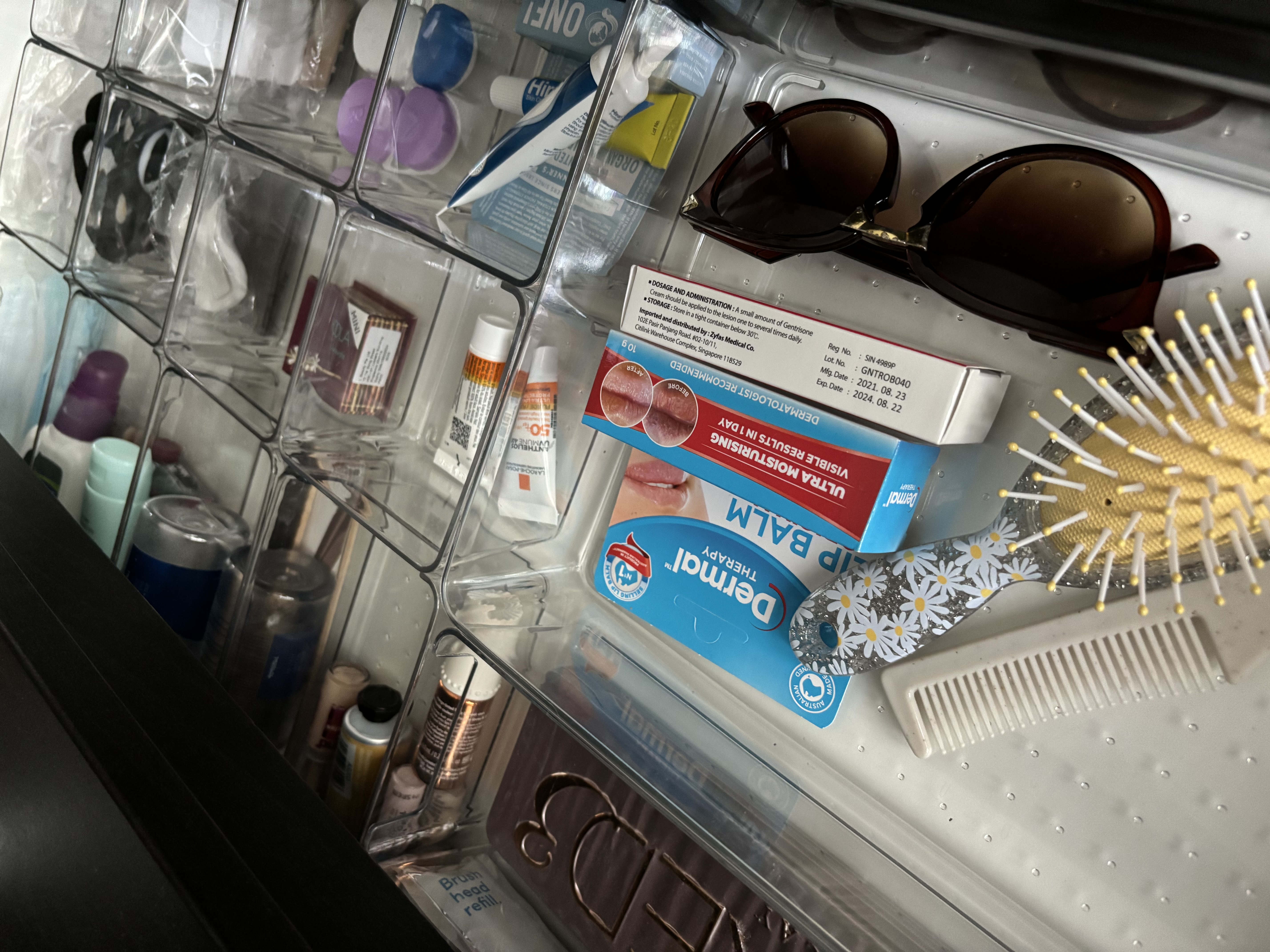 Simple home organisation tips you can try! - Clear plastic storage drawer, various toiletries, sunglasses, dental floss