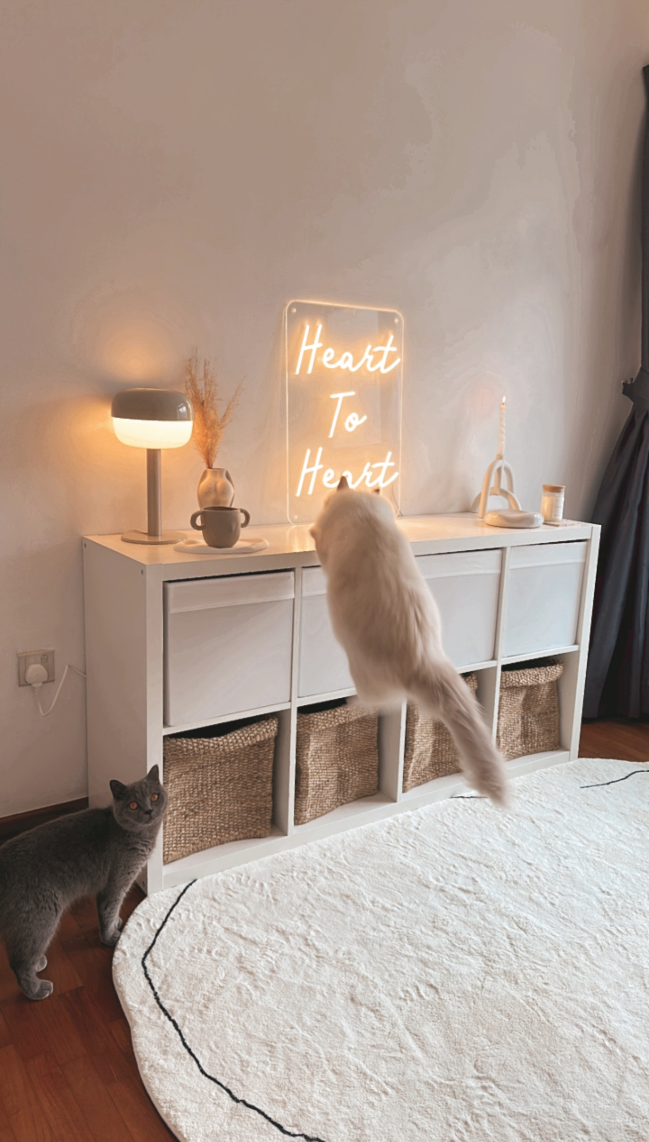 Our Studio Office: Where Our Work Takes Place, Literally 📸📽️🎞️ - White minimalist dresser, neon sign "Heart To Heart, "