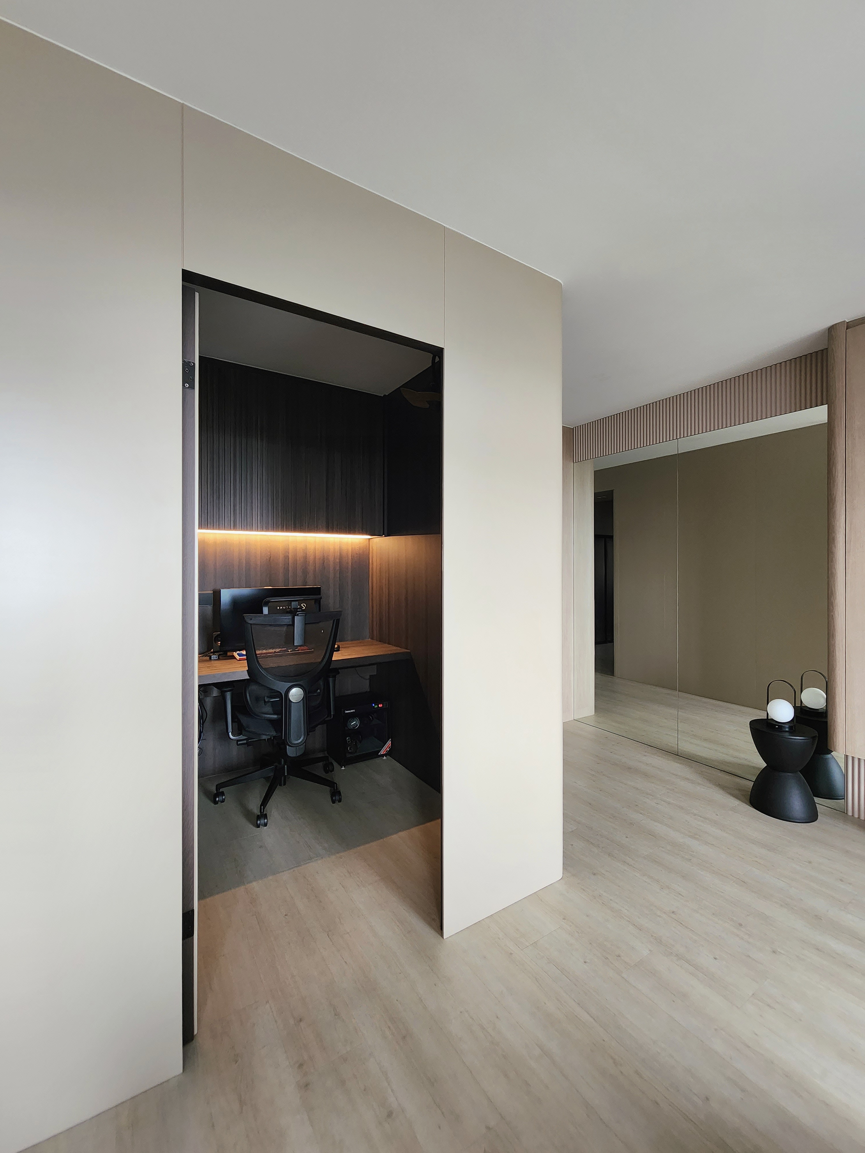 Our Closet Office: Small Space Big Impact - Modern minimalist home office, sleek black office chair, wooden desk, ambient