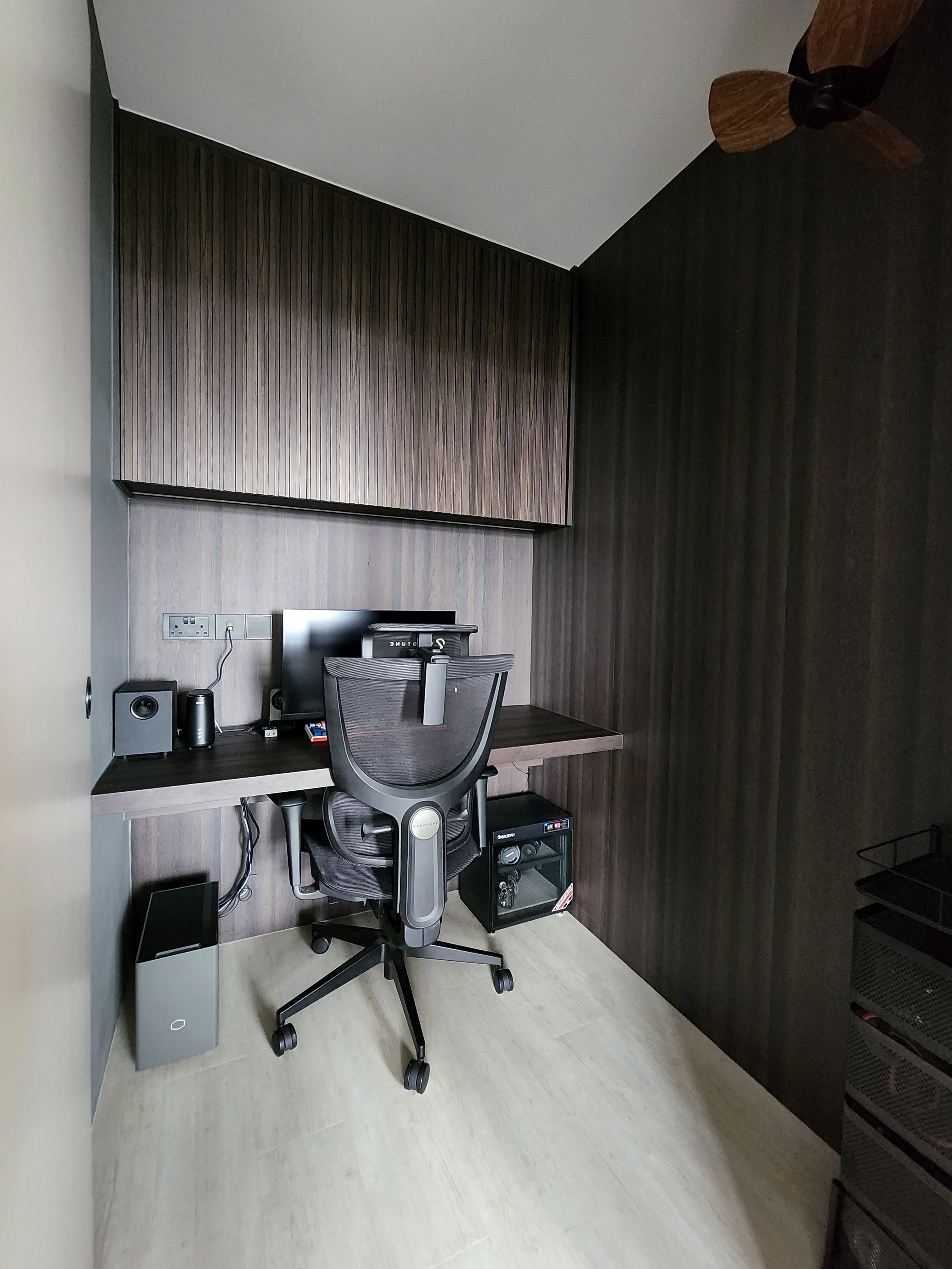 Our Closet Office: Small Space Big Impact - Wooden cabinetry, modern desk, ergonomic chair, black speaker, computer monitor