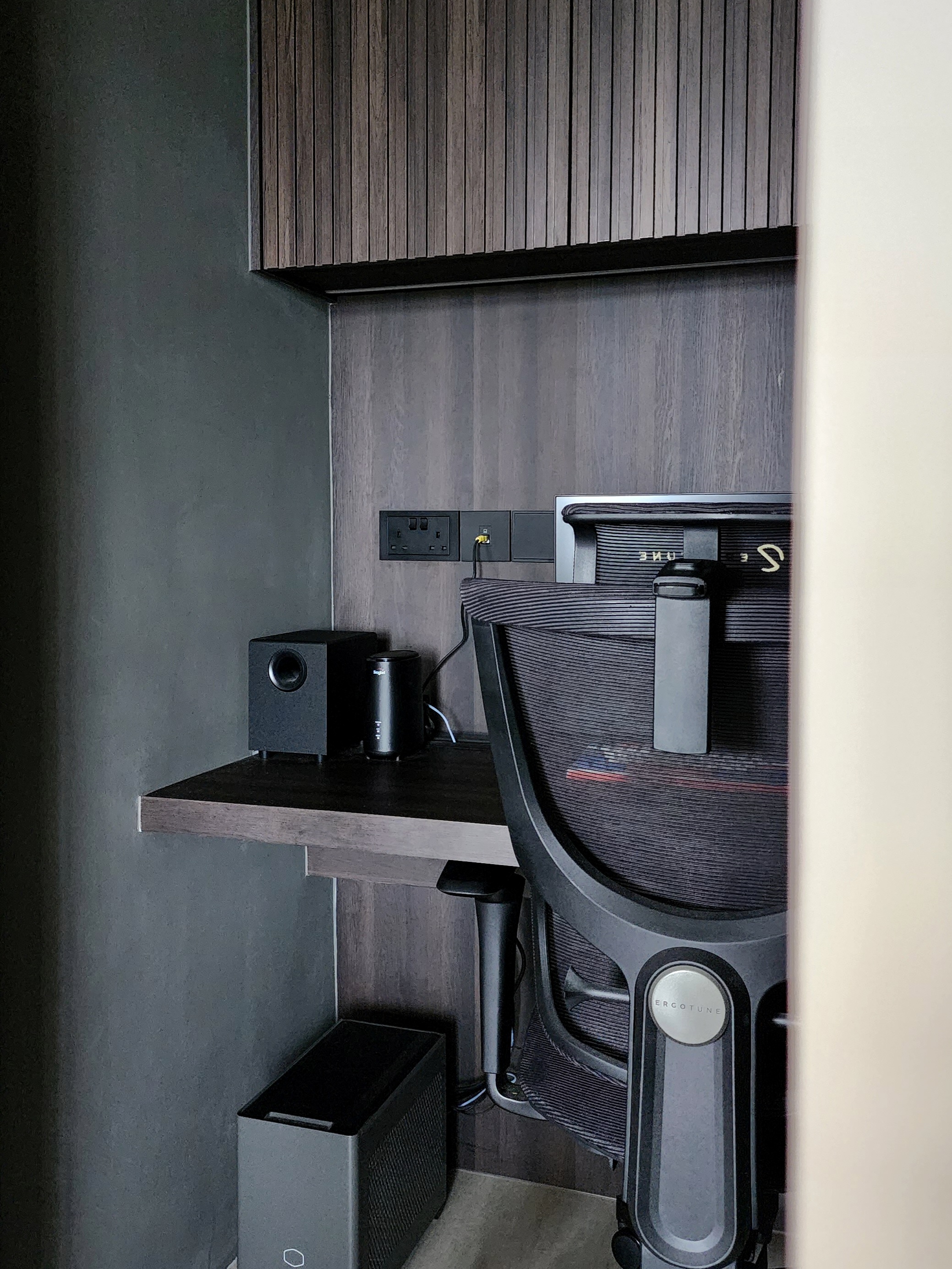 Our Closet Office: Small Space Big Impact - Wooden desk, modern office chair, black speaker, ergonomic chair, compact