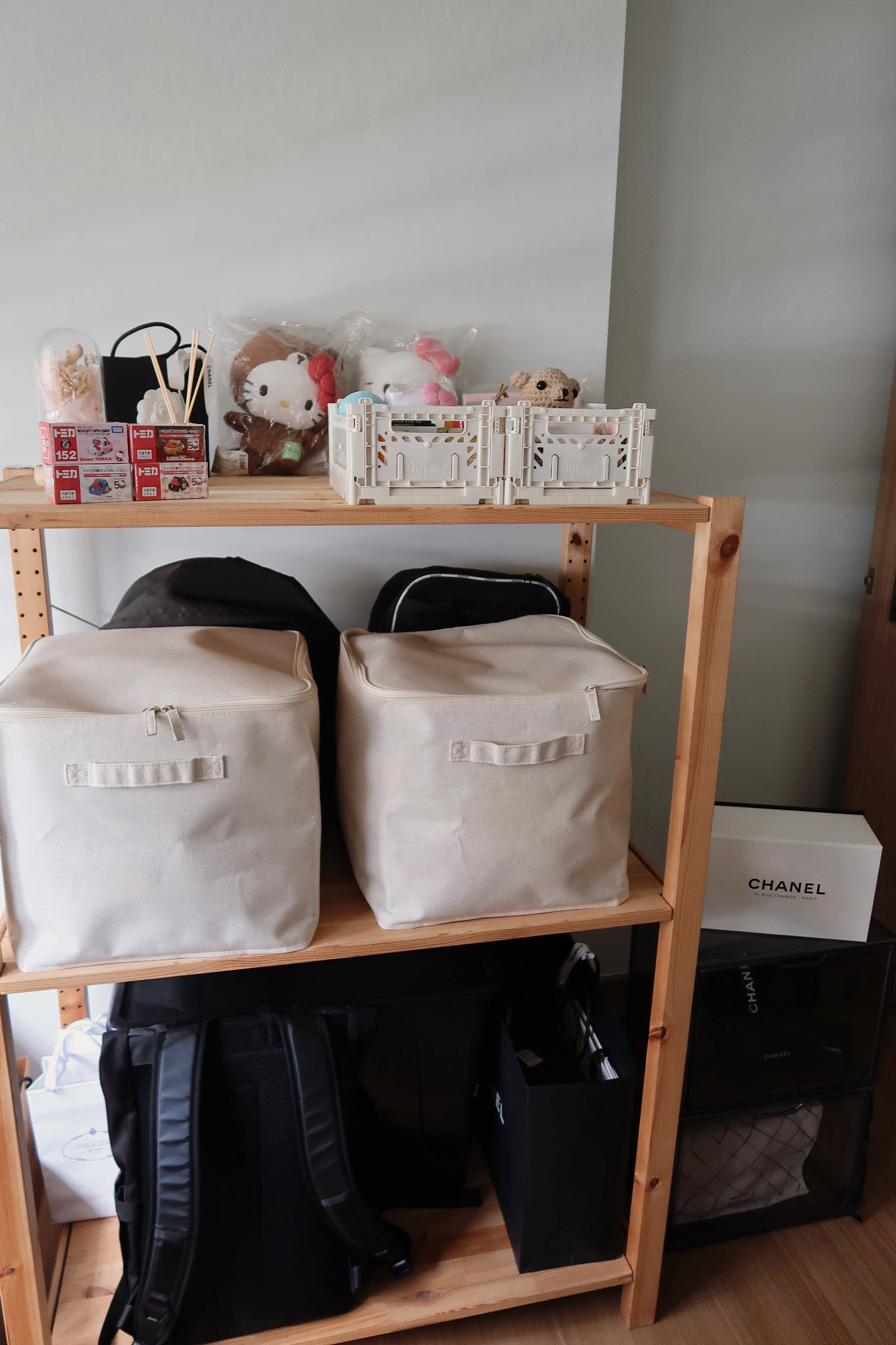 Our work space customised to our needs  - Shelves, bags, beige, fabric, storage, boxes, Hello Kitty, toys, black backpack