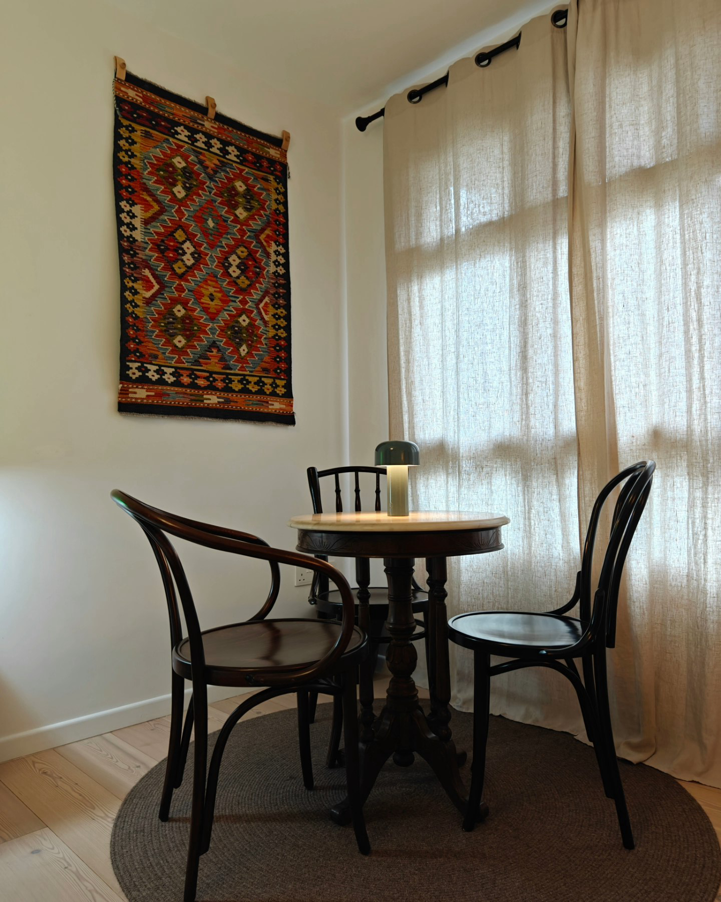 Change Is A Constant! - Dining room, table, chairs, rug, wall hanging, patterned rug, beige curtains, wooden chair, round