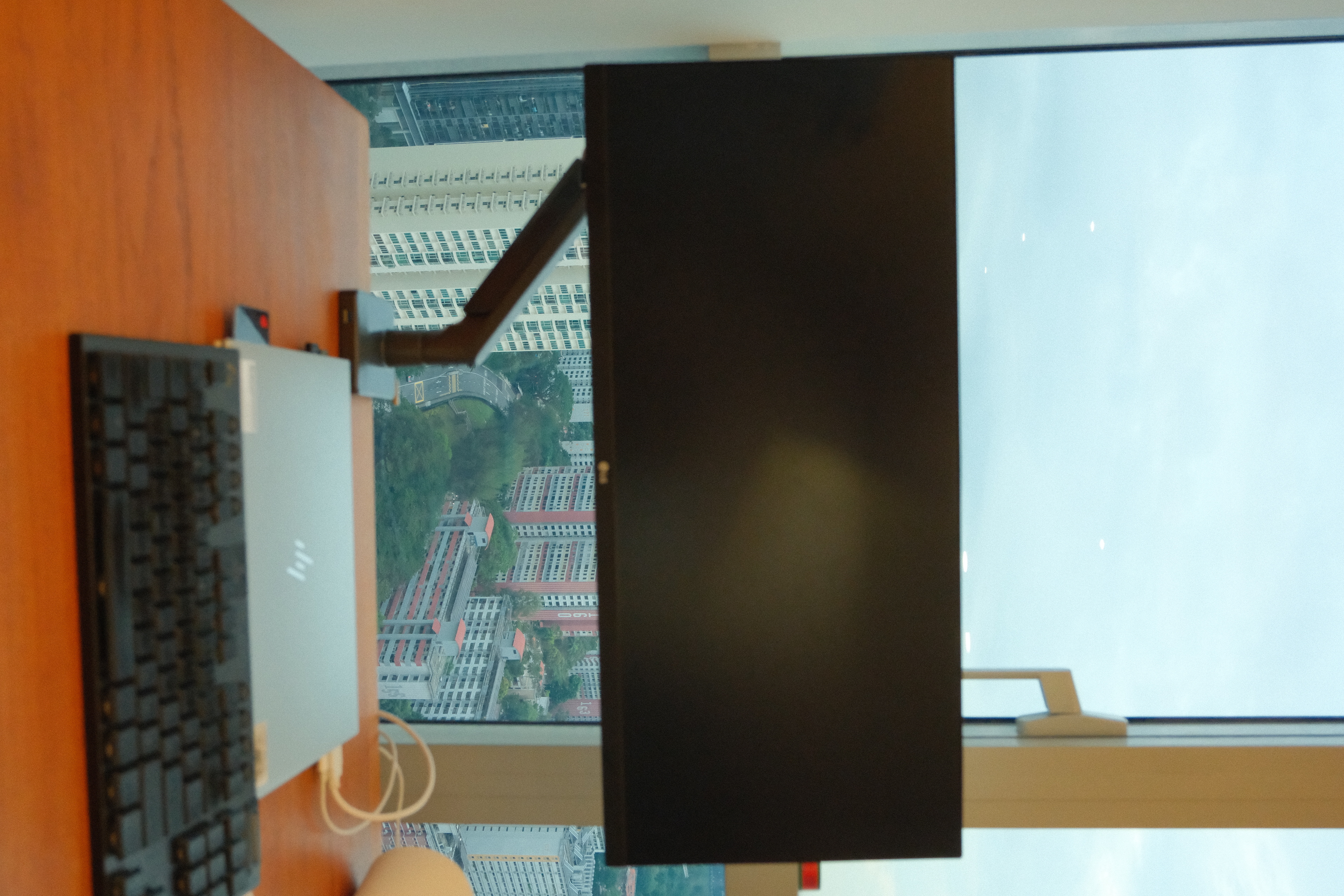 Study with a view! - Modern workspace with sleek black keyboard and laptop, Large window offering panoramic cityscape view