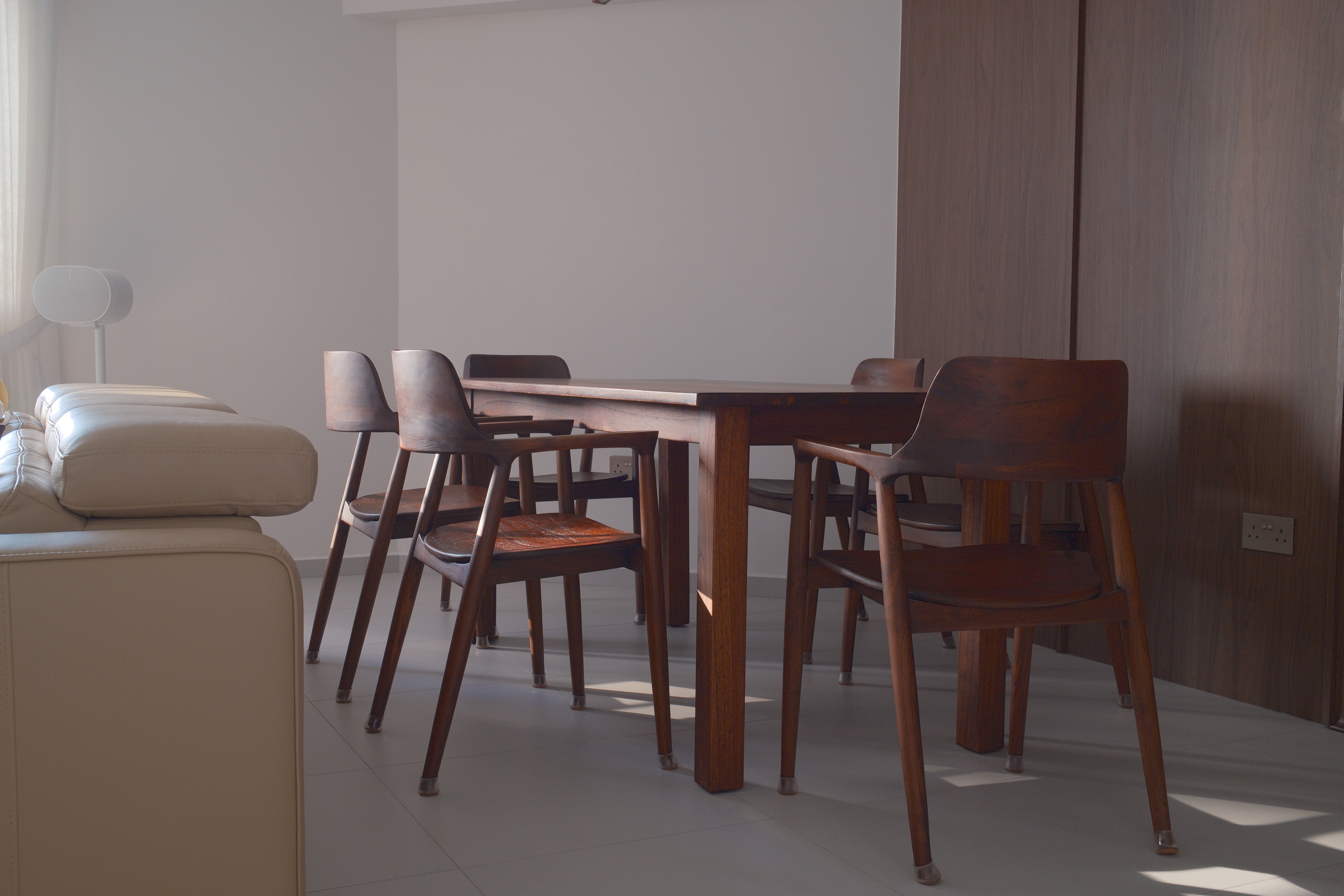 What we've learnt about hosting - Modern minimalist dining room, sleek wooden dining table, stylish wooden chairs, neutral