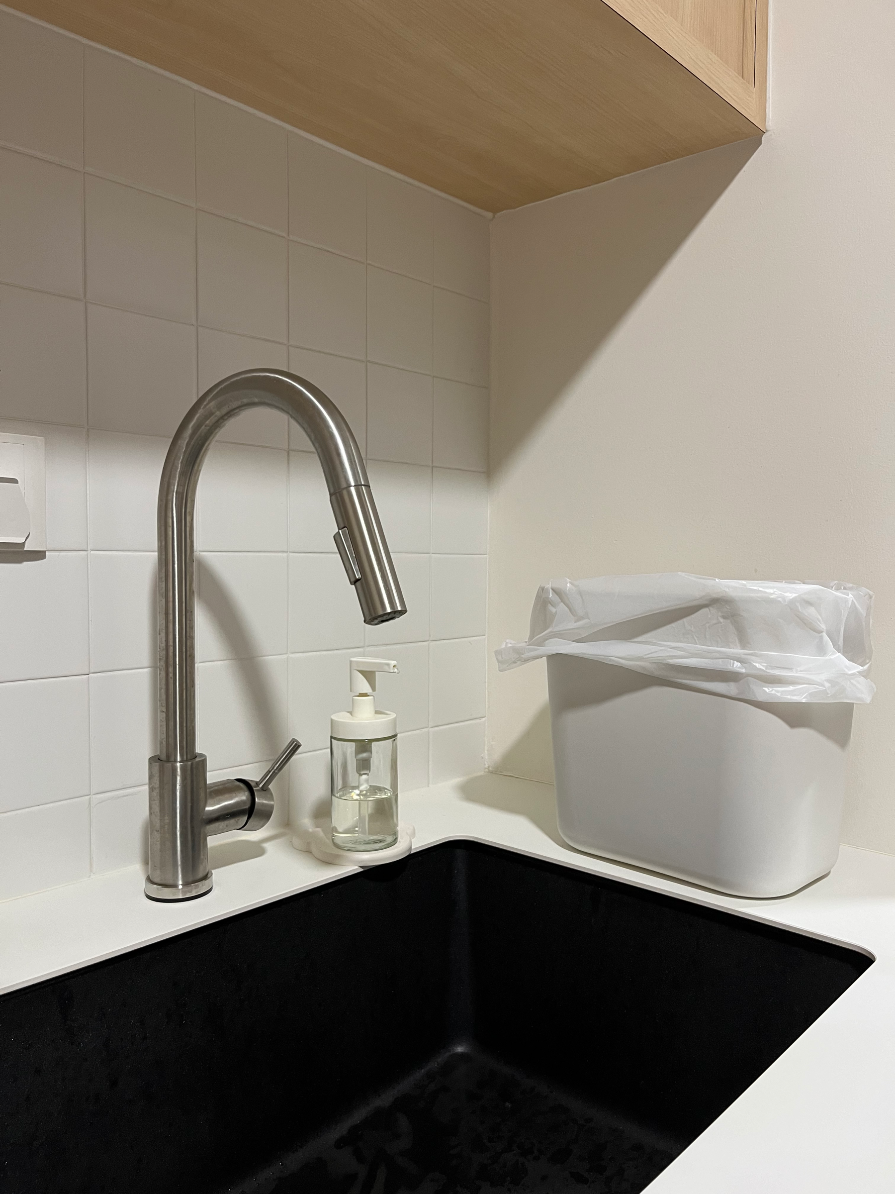 Most Asked About Things in Our Home! - Silver faucet, white tiled wall, black sink, wooden cabinet, white soap dispenser