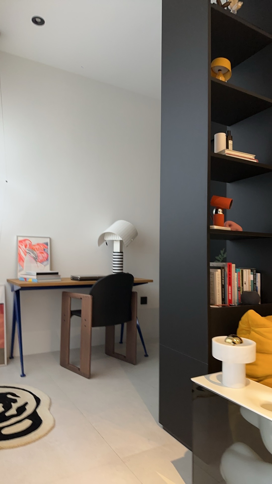 Behind the Bookshelf – Our Minimalist Study Area - Modern minimalist home office, sleek desk, black chair, abstract painting