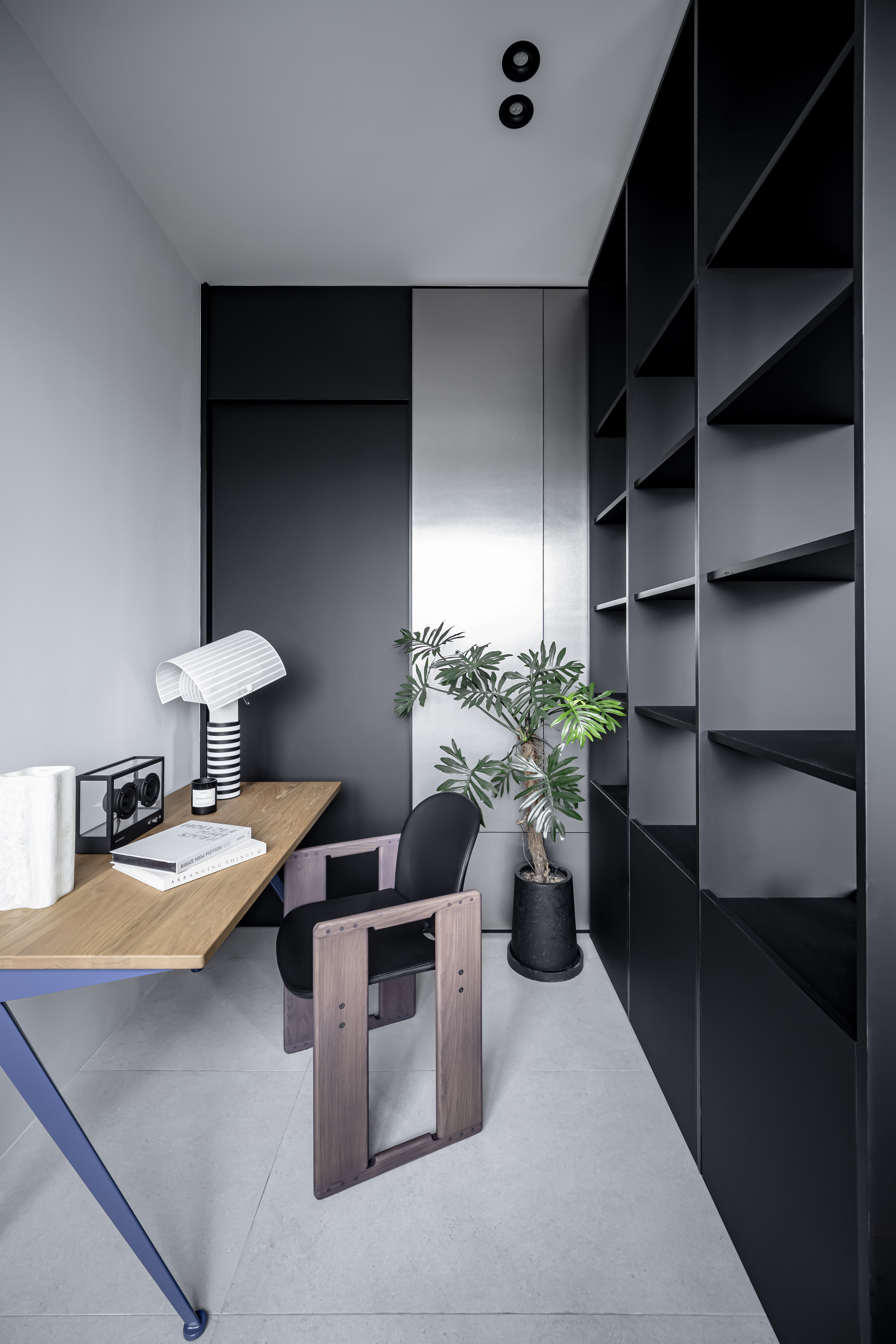 Behind the Bookshelf – Our Minimalist Study Area - Modern minimalist office space, sleek desk, black and white striped lamp