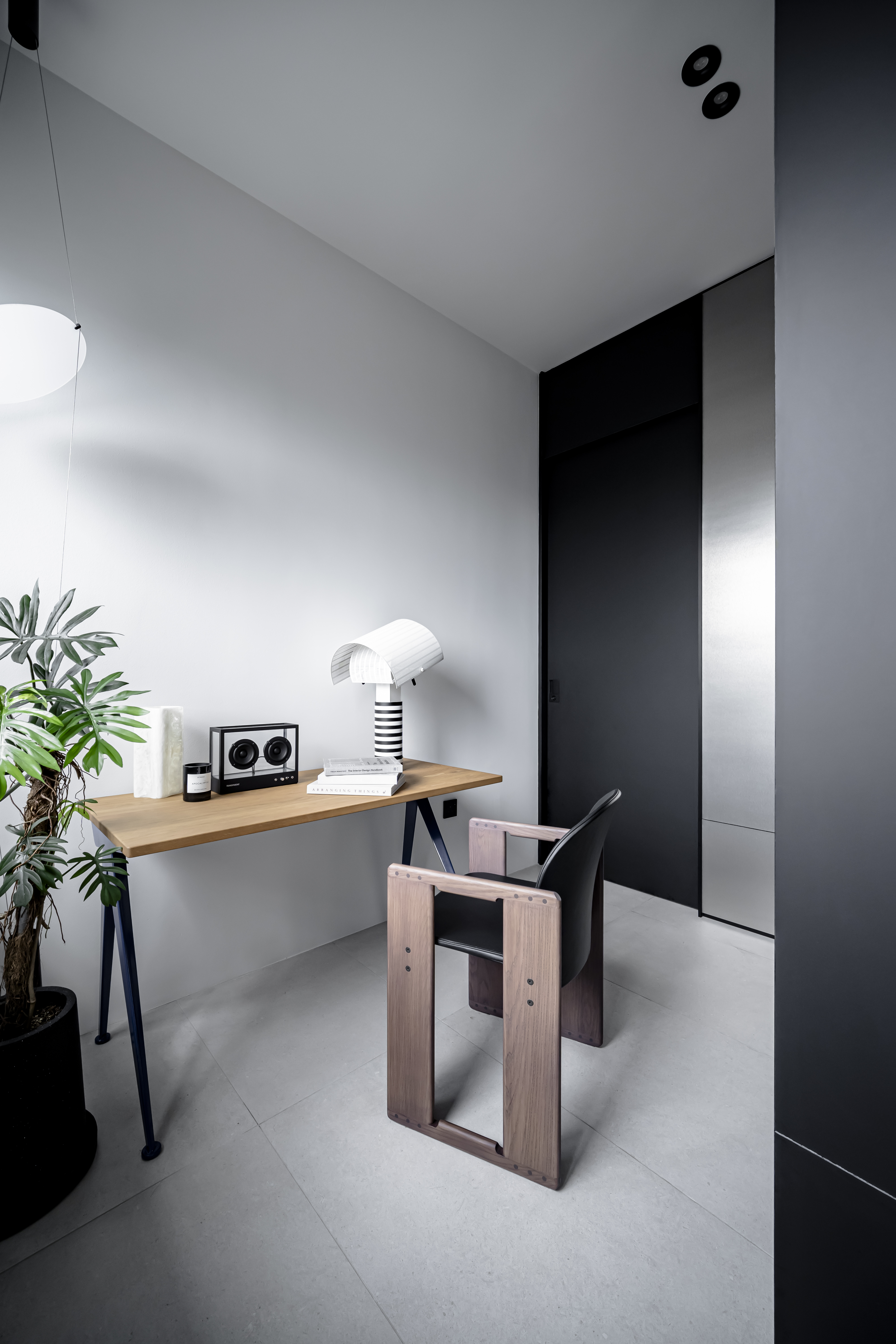 Behind the Bookshelf – Our Minimalist Study Area - Modern minimalist office space, sleek desk, black and white decor, wooden