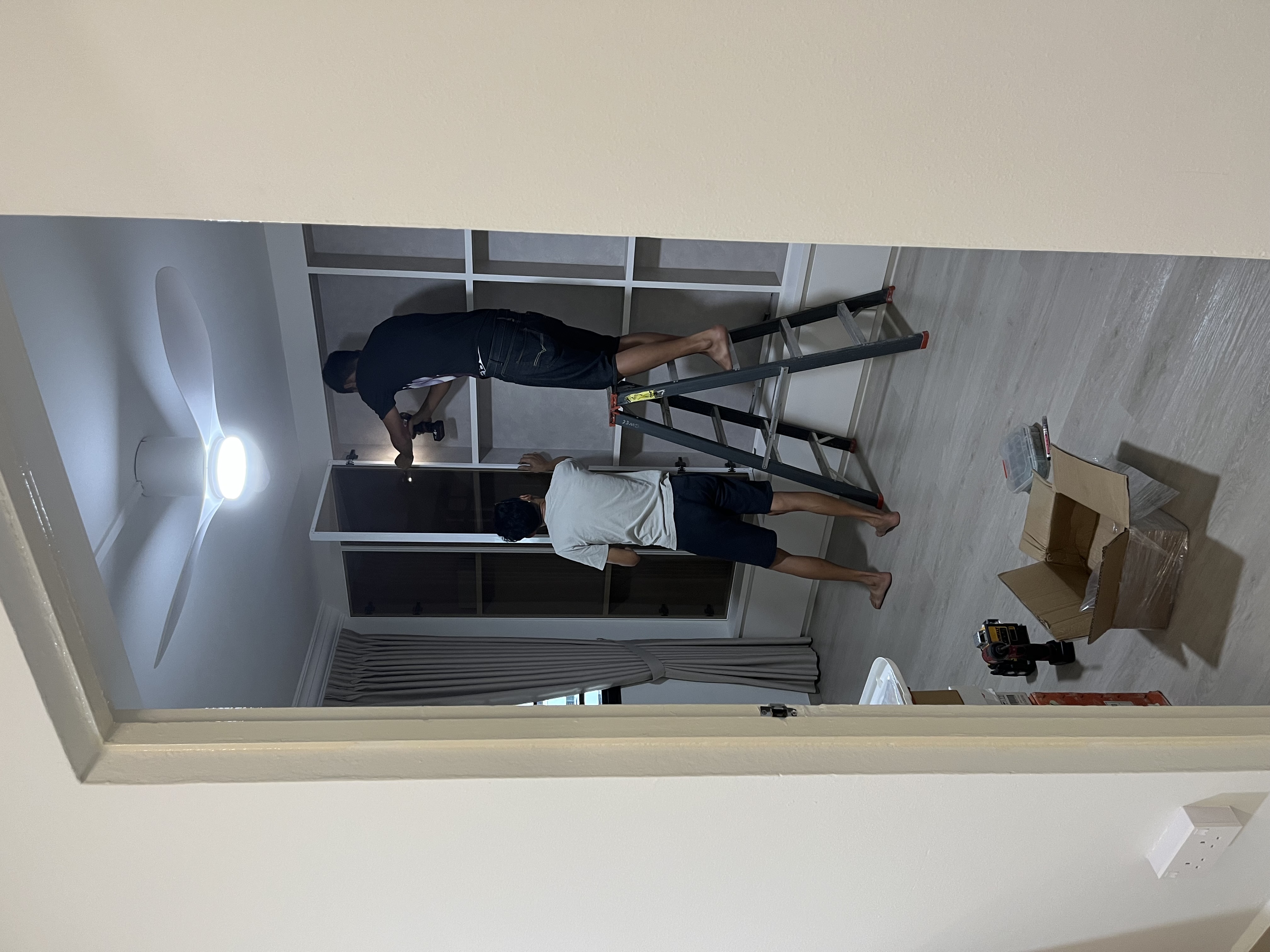 Design the display cabinet of your dreams - Two individuals working on ceiling fan installation, Interior space with large