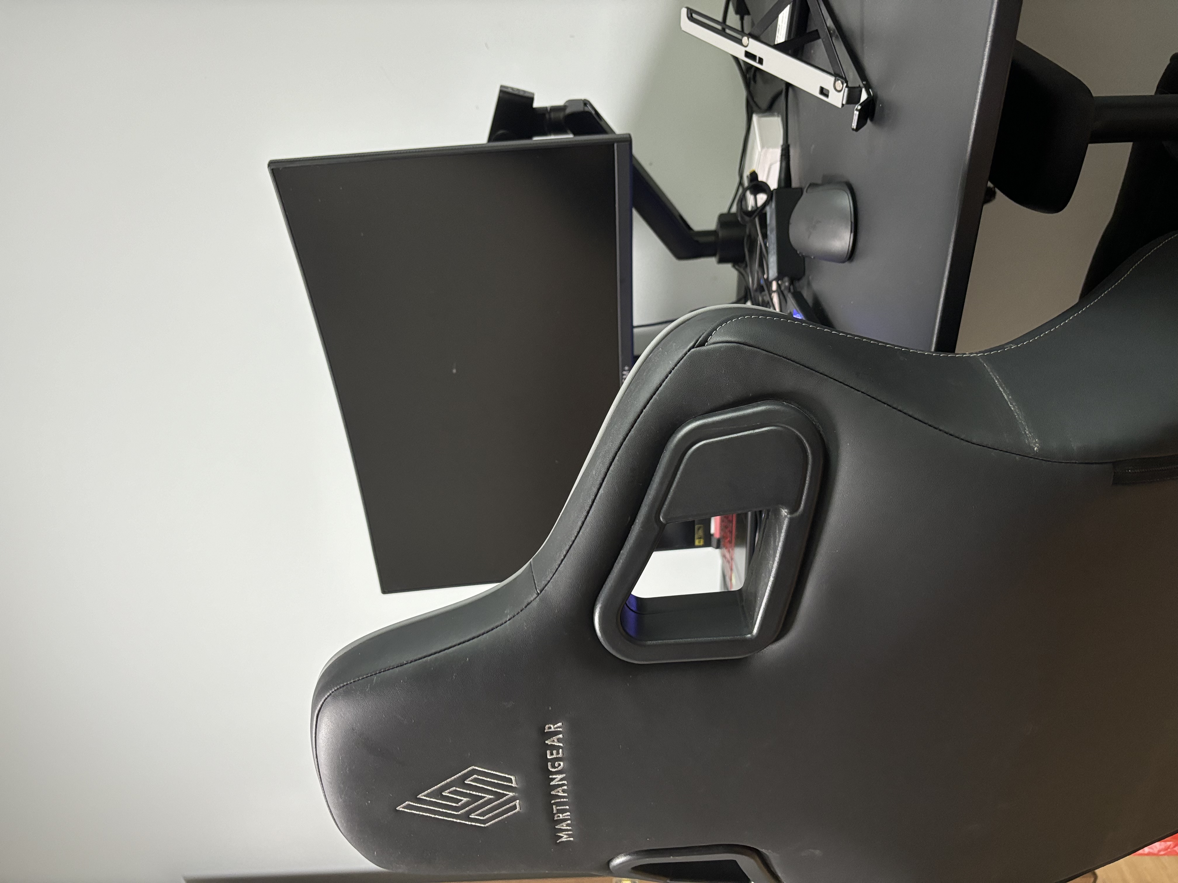 The Ultimate Home Office Experience for the Homebody - Black gaming chair, black leather upholstery, MartiGear logo