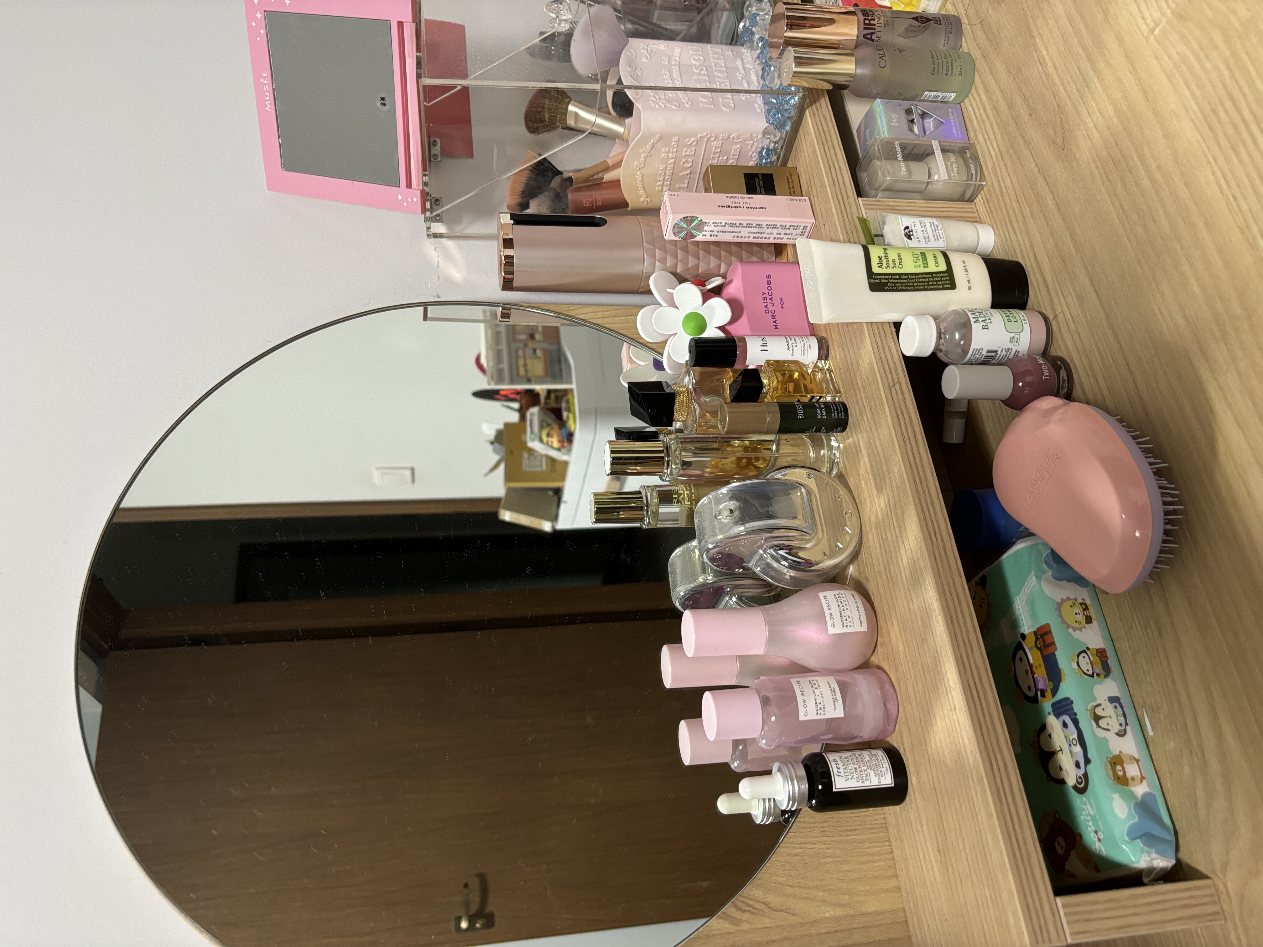 The Ultimate Home Office Experience for the Homebody - Pink vanity mirror, makeup products, skincare items, cosmetics, beauty