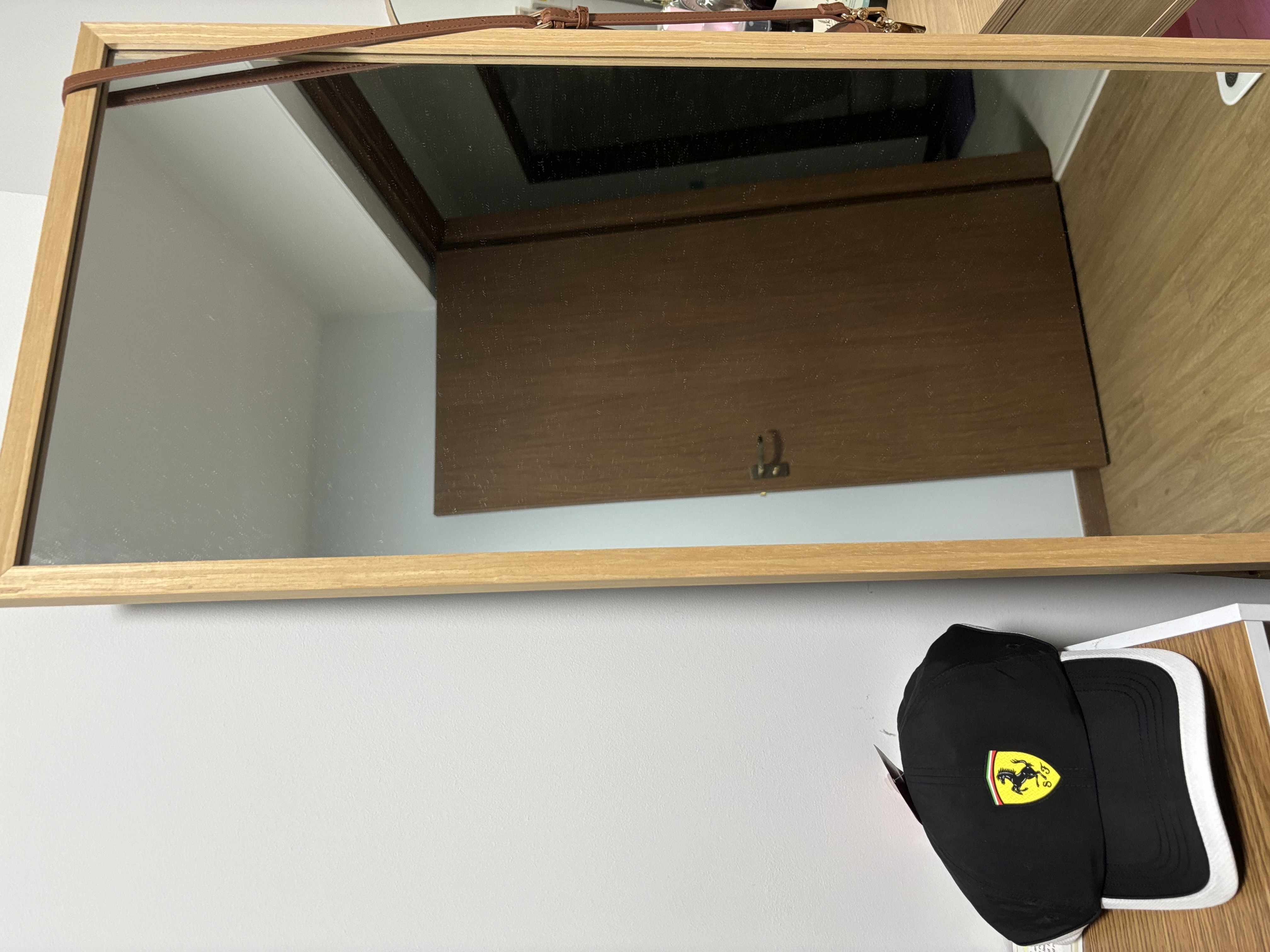 The Ultimate Home Office Experience for the Homebody - Mirror reflection, wooden frame, brown leather strap, wooden wardrobe