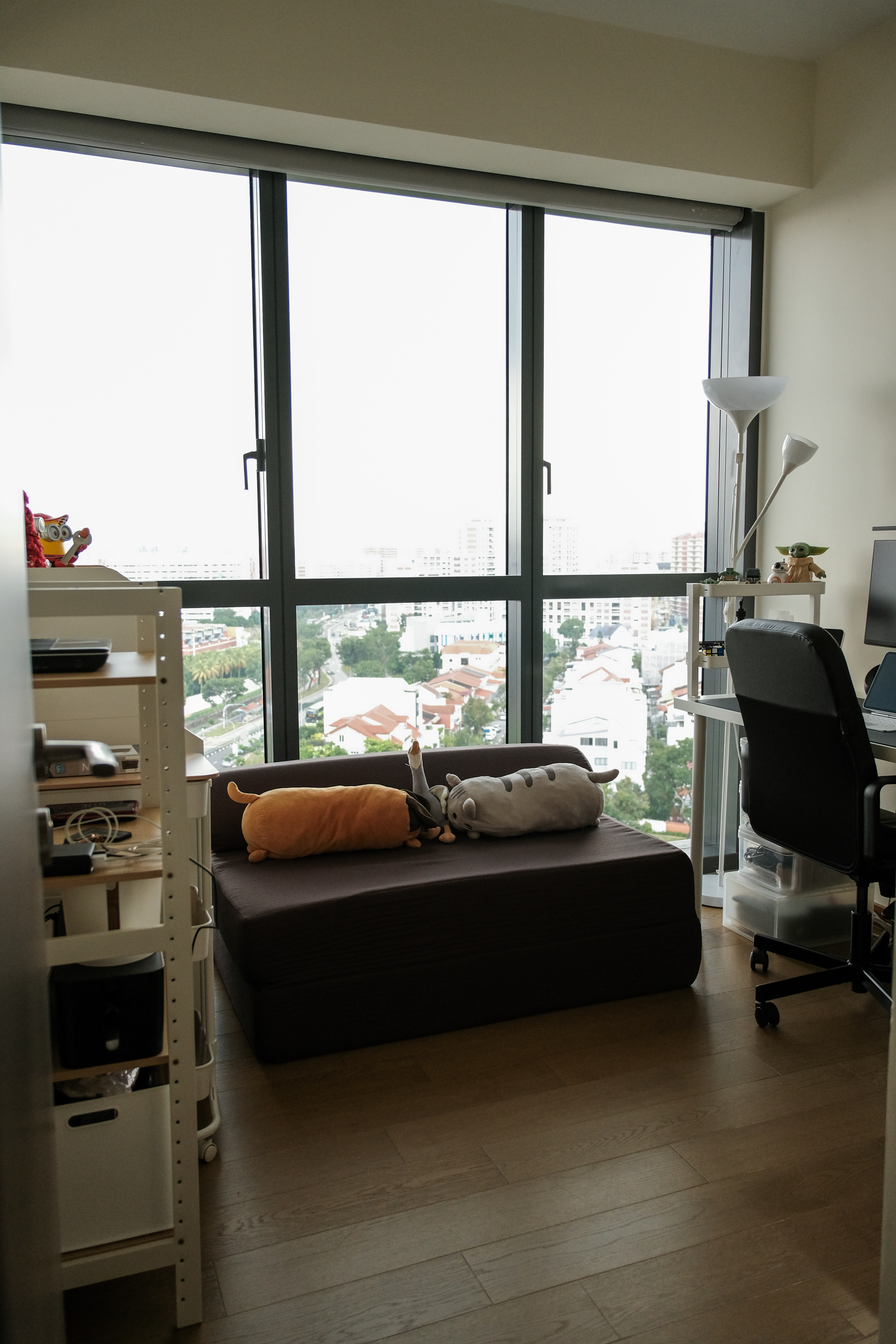 Our versatile guest room/study room! ✨ - Large window, cityscape, indoor view, cozy room, modern decor, plush toys, black