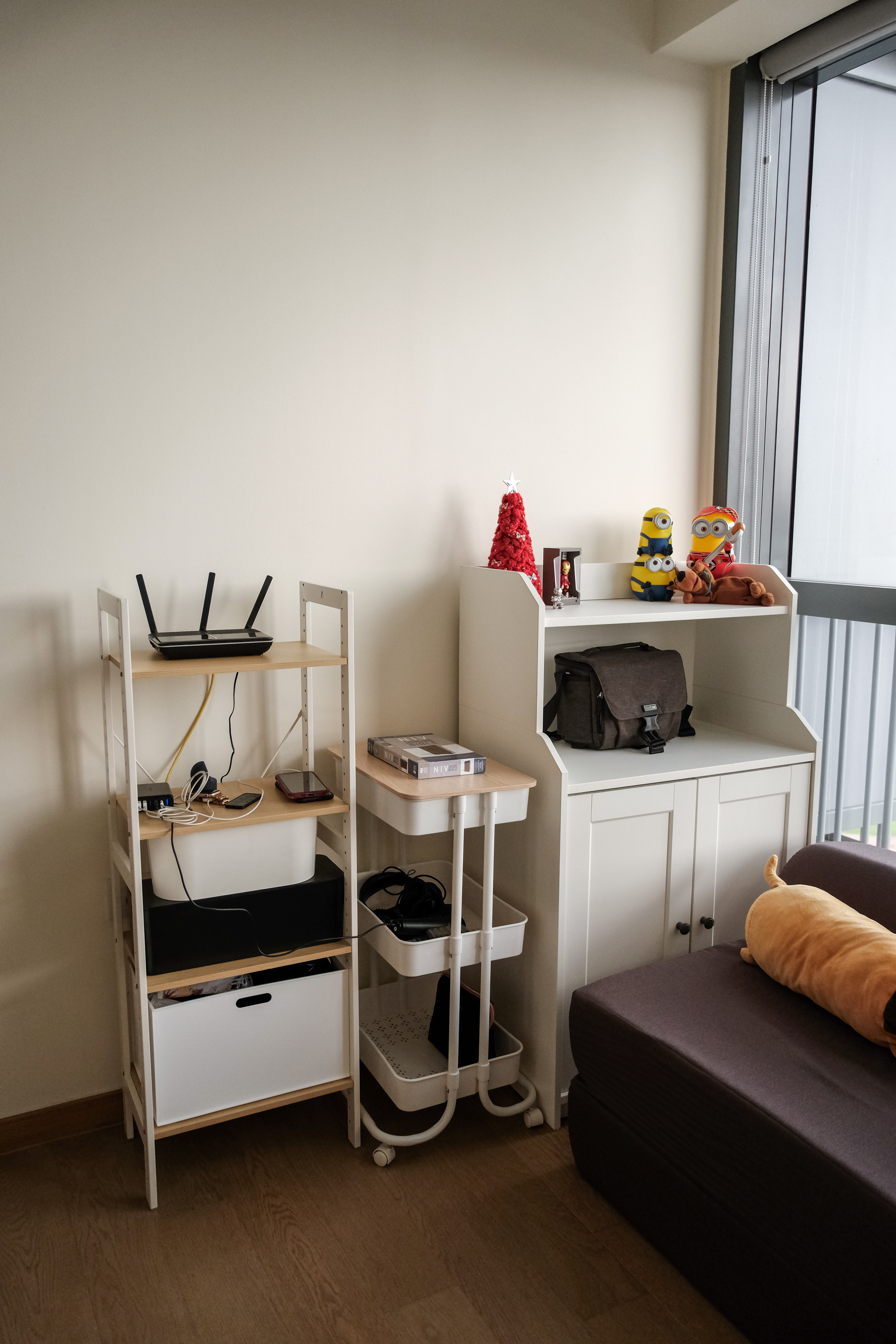 Our versatile guest room/study room! ✨ - Wireless router on shelf, white shelving unit, small Christmas tree, Minion toys