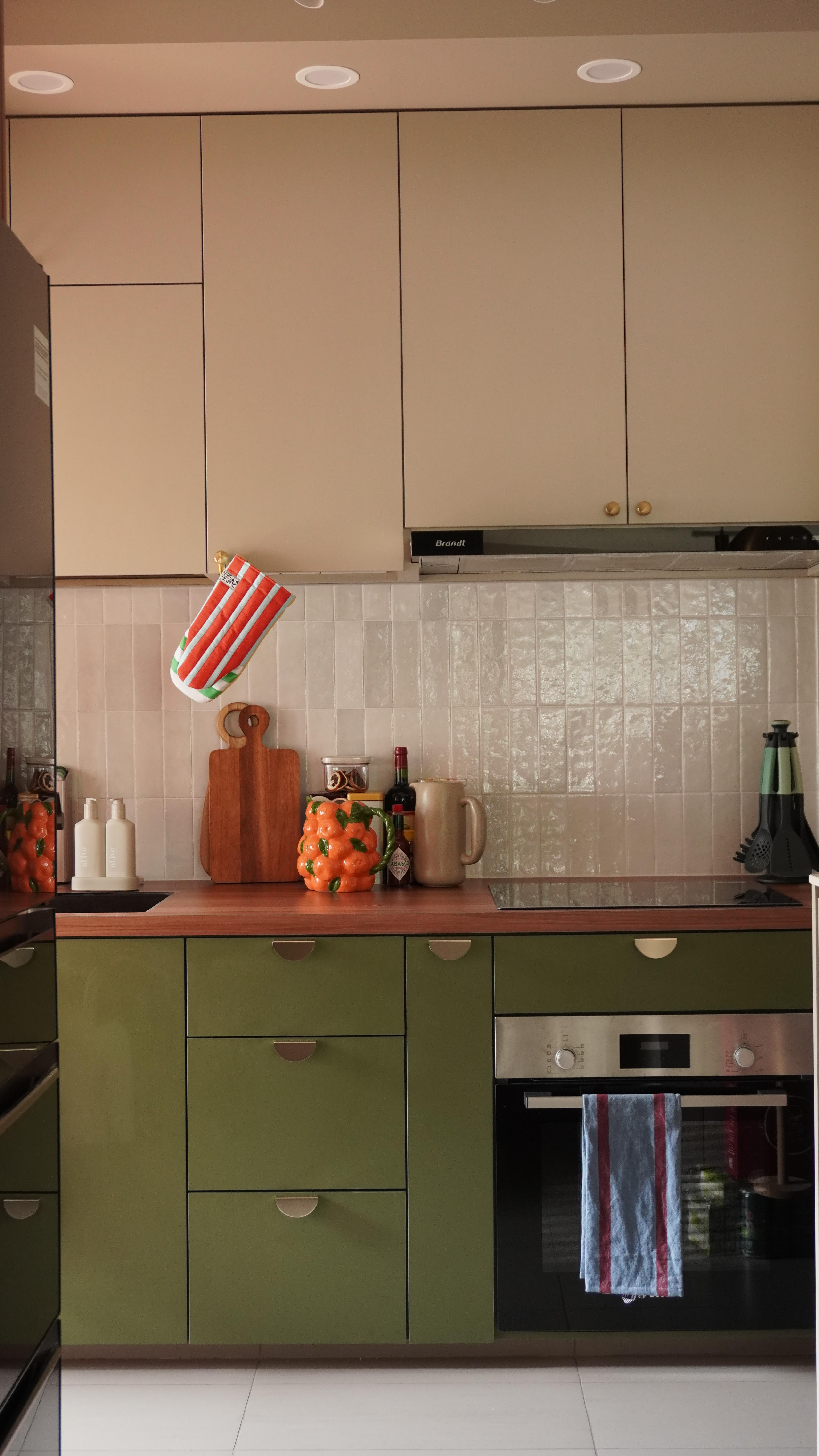 Keeping the clutter away in our Kitchen! - Green kitchen cabinets, beige upper cabinets, white tiled backsplash, wooden