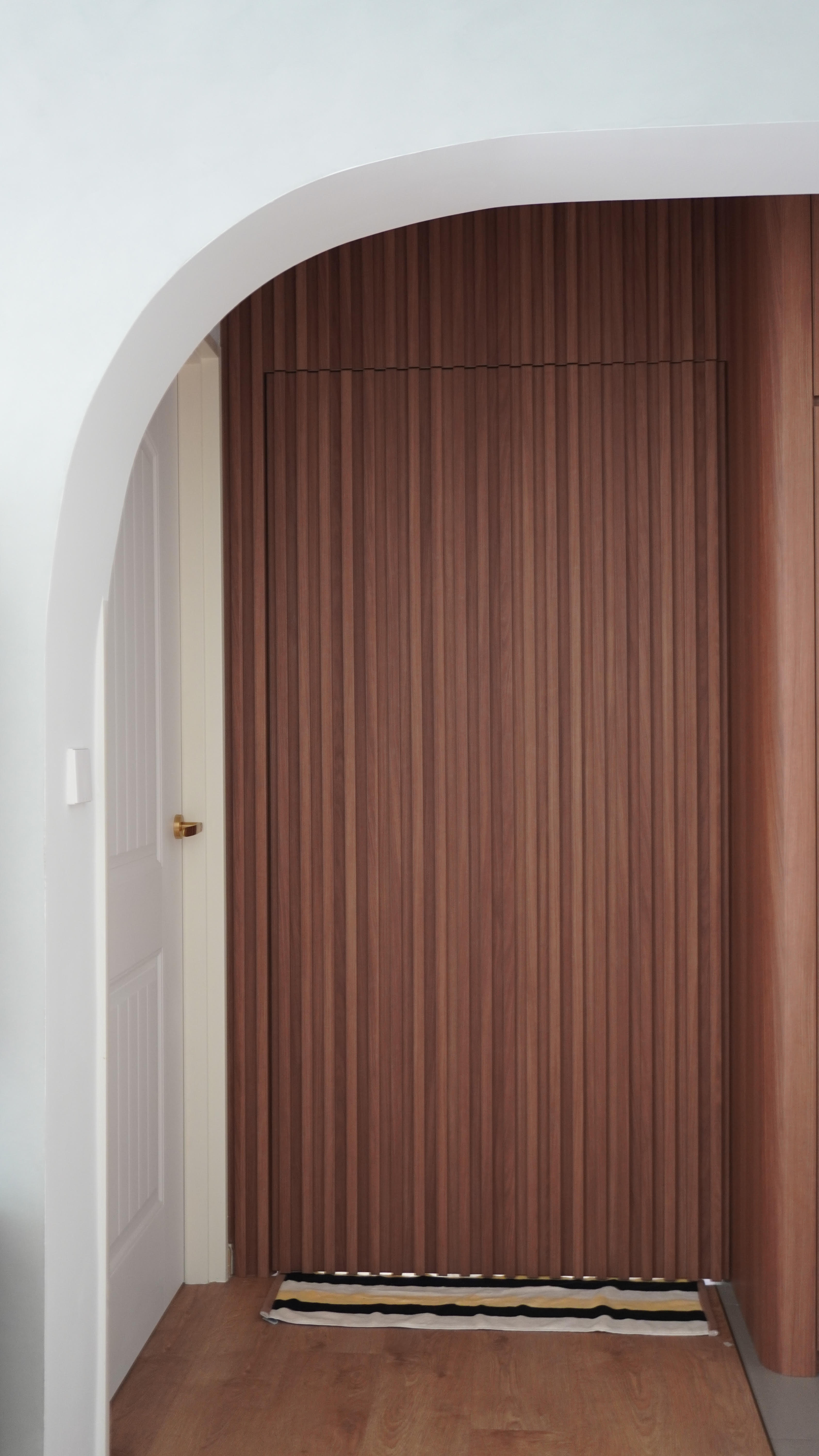 Simple solutions to hide the mess!  - Wooden paneling, arched doorway, vertical slats, modern design, wooden texture, warm
