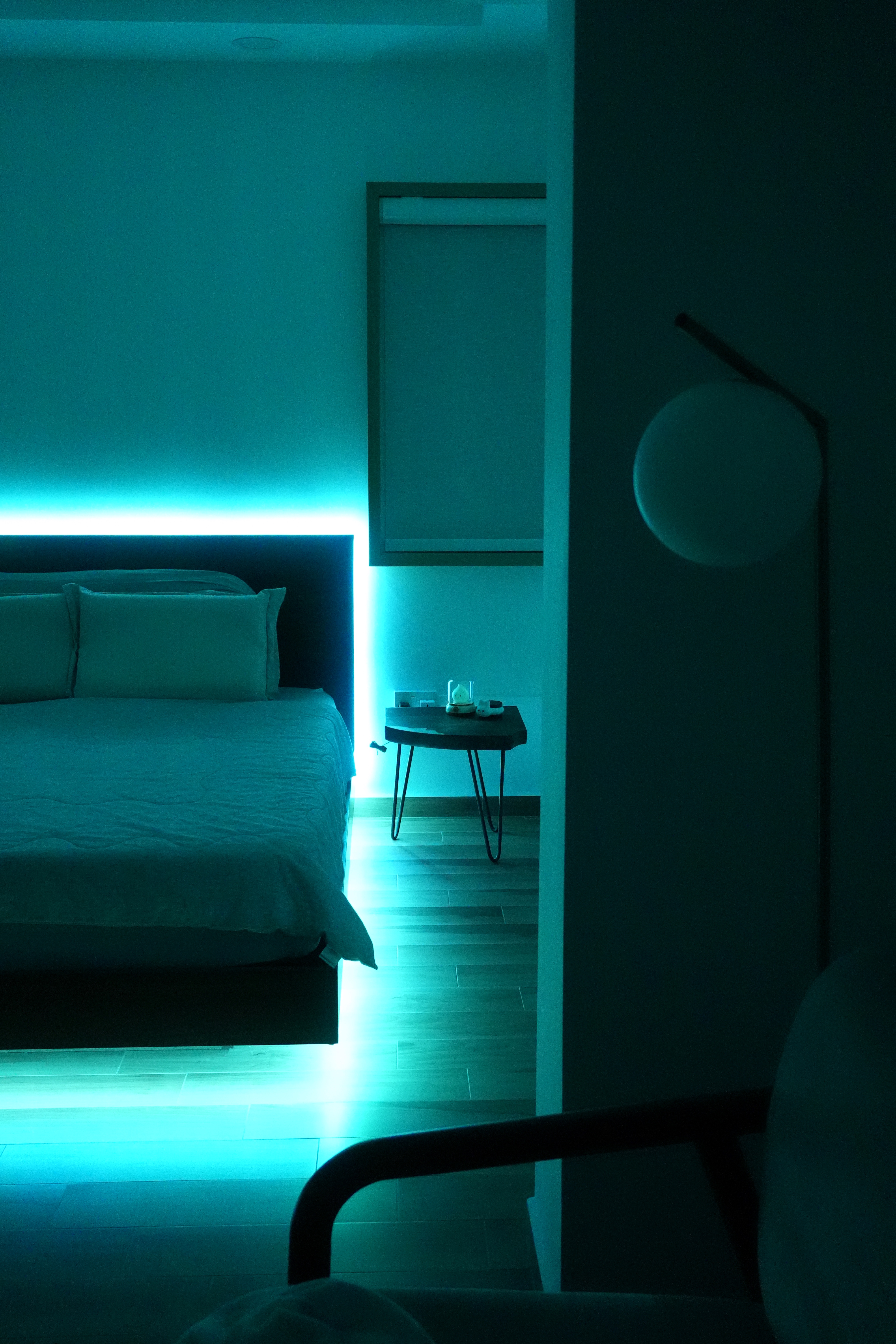 Transform your bedroom with this DIY ‘Floating Bed’ light trick! - Modern bedroom with teal lighting, minimalist design, bed
