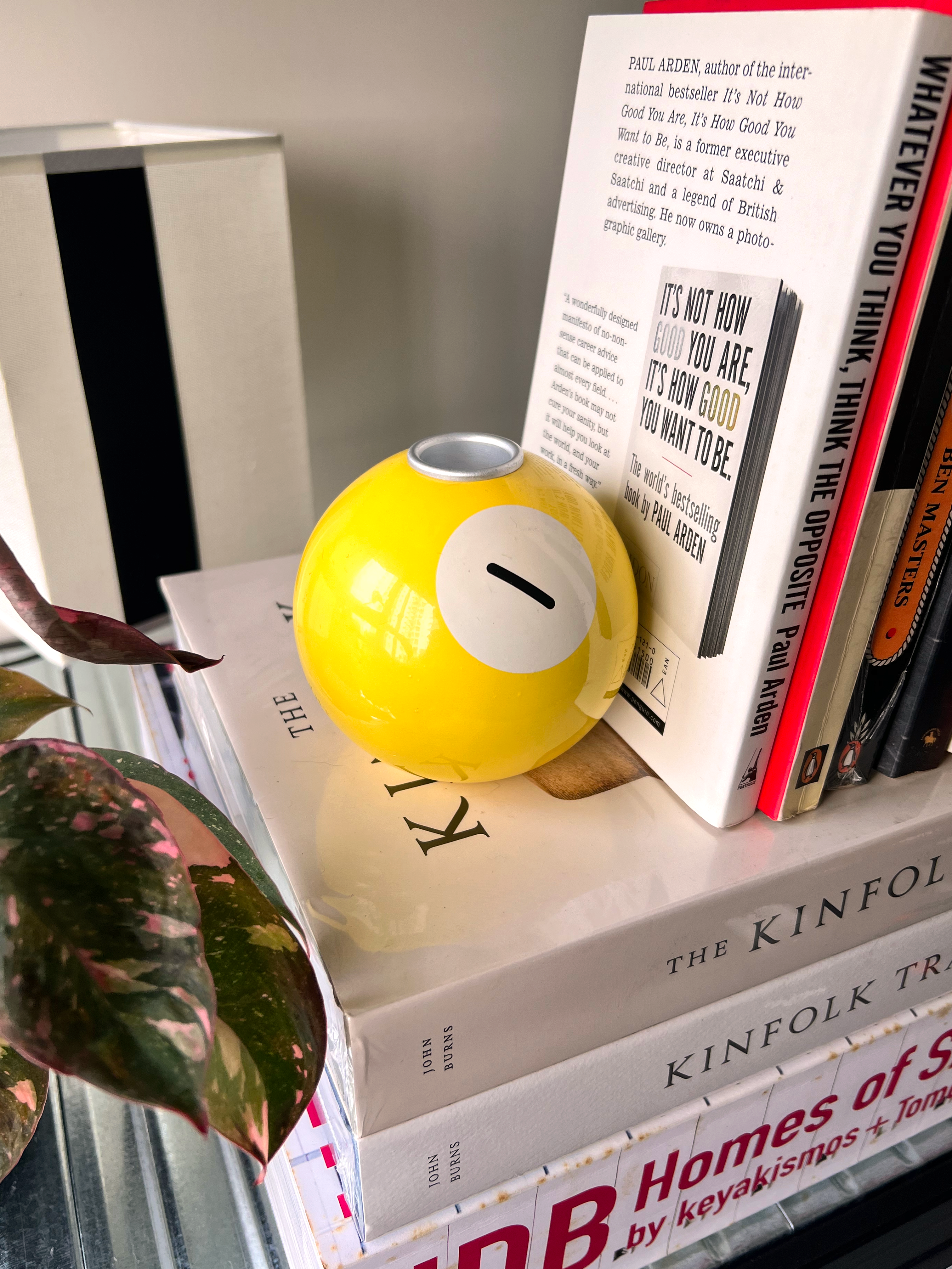 Organising a functional and aesthetic shelf for 2 monkeys 🙉🙊 - Yellow spherical object, book titled "The Kinfolk Tradition
