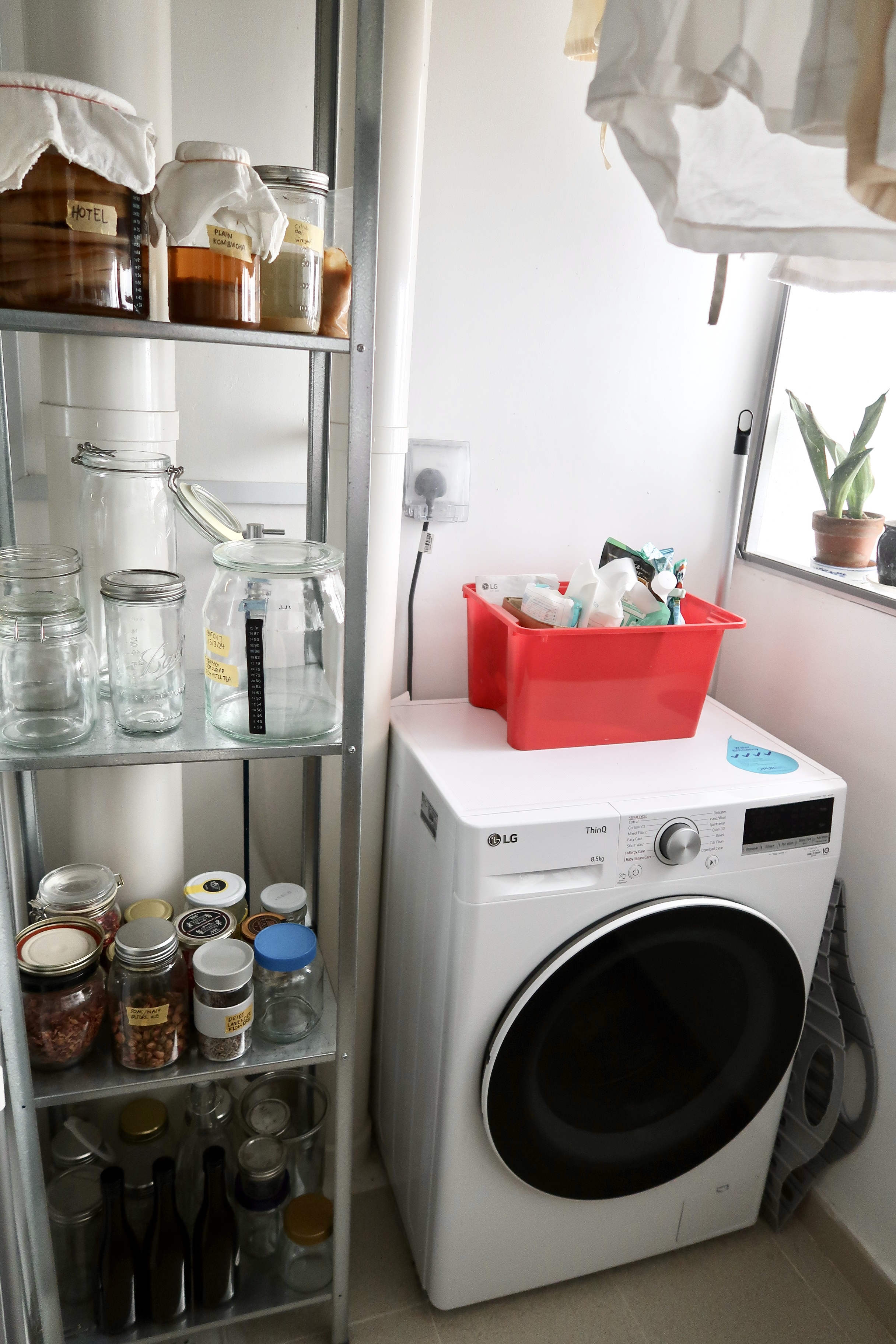 Multi-Use Service Yard with a Fermentation Nook  - glass jars, glass containers, white laundry detergent, laundry basket
