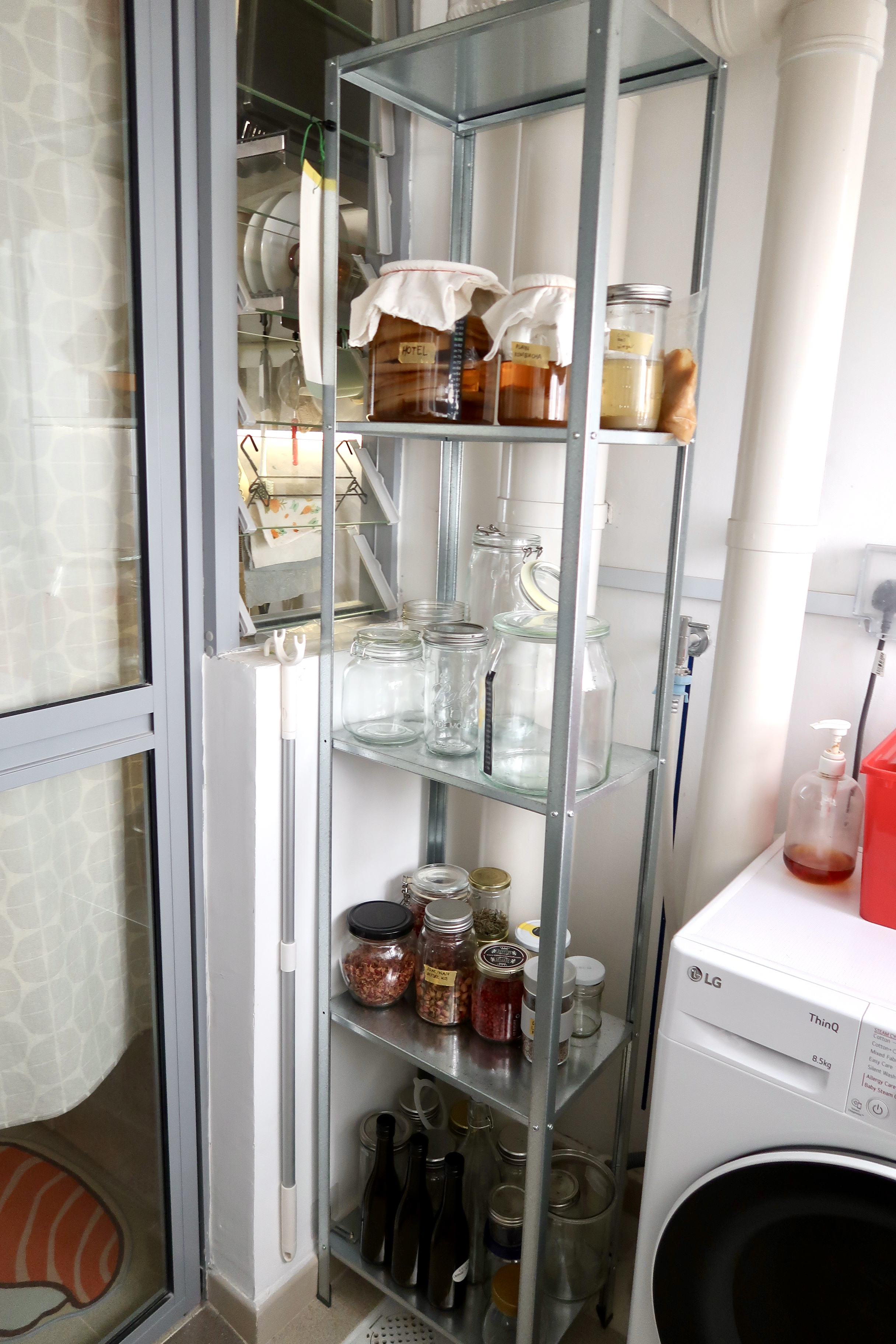 Multi-Use Service Yard with a Fermentation Nook  - Glass-fronted metal shelf, glass jars, plastic bottles, glass jars on