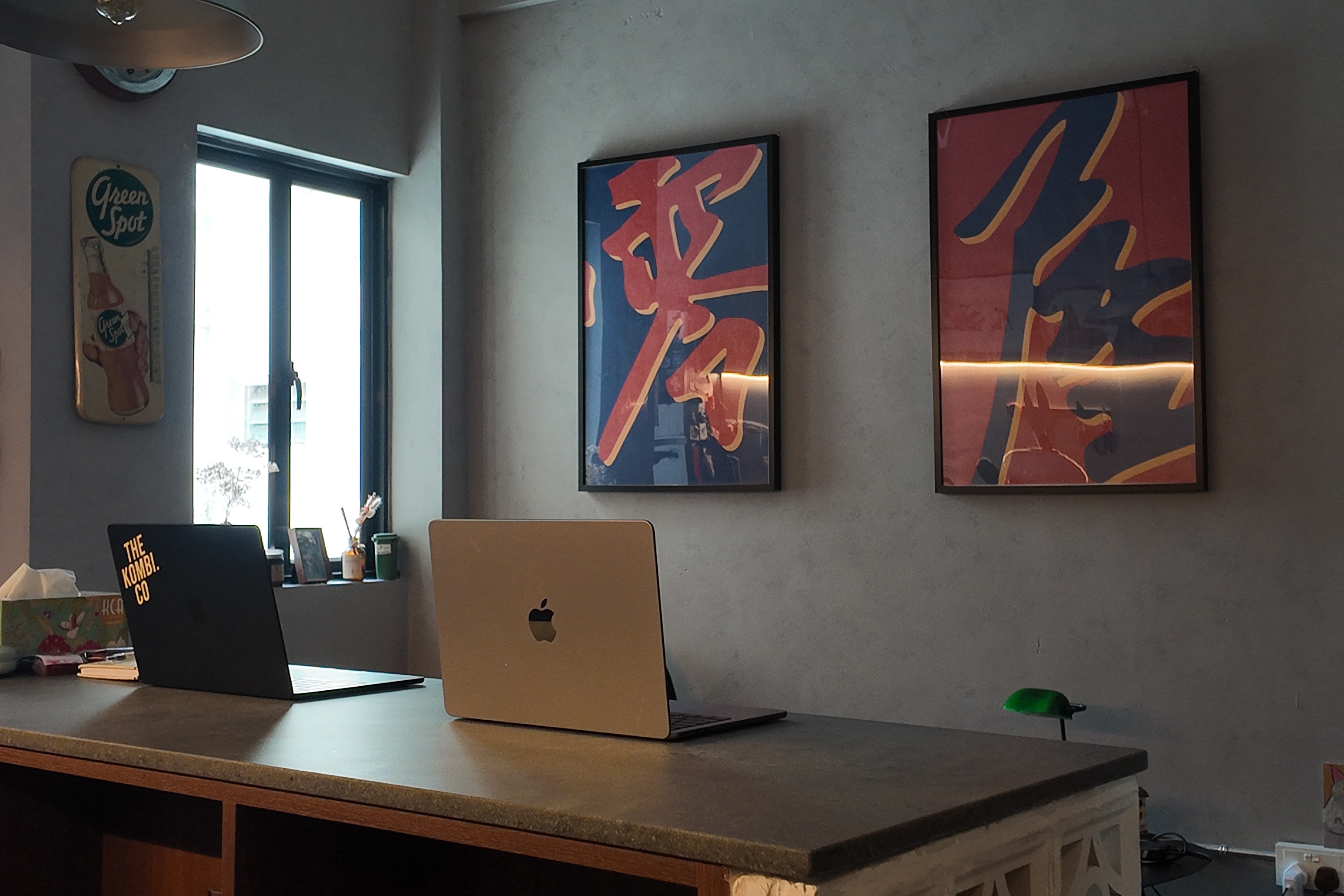Work, Werk, Werk, Werk, Werk - Modern workspace with sleek design, Apple laptops on a polished countertop, Two framed