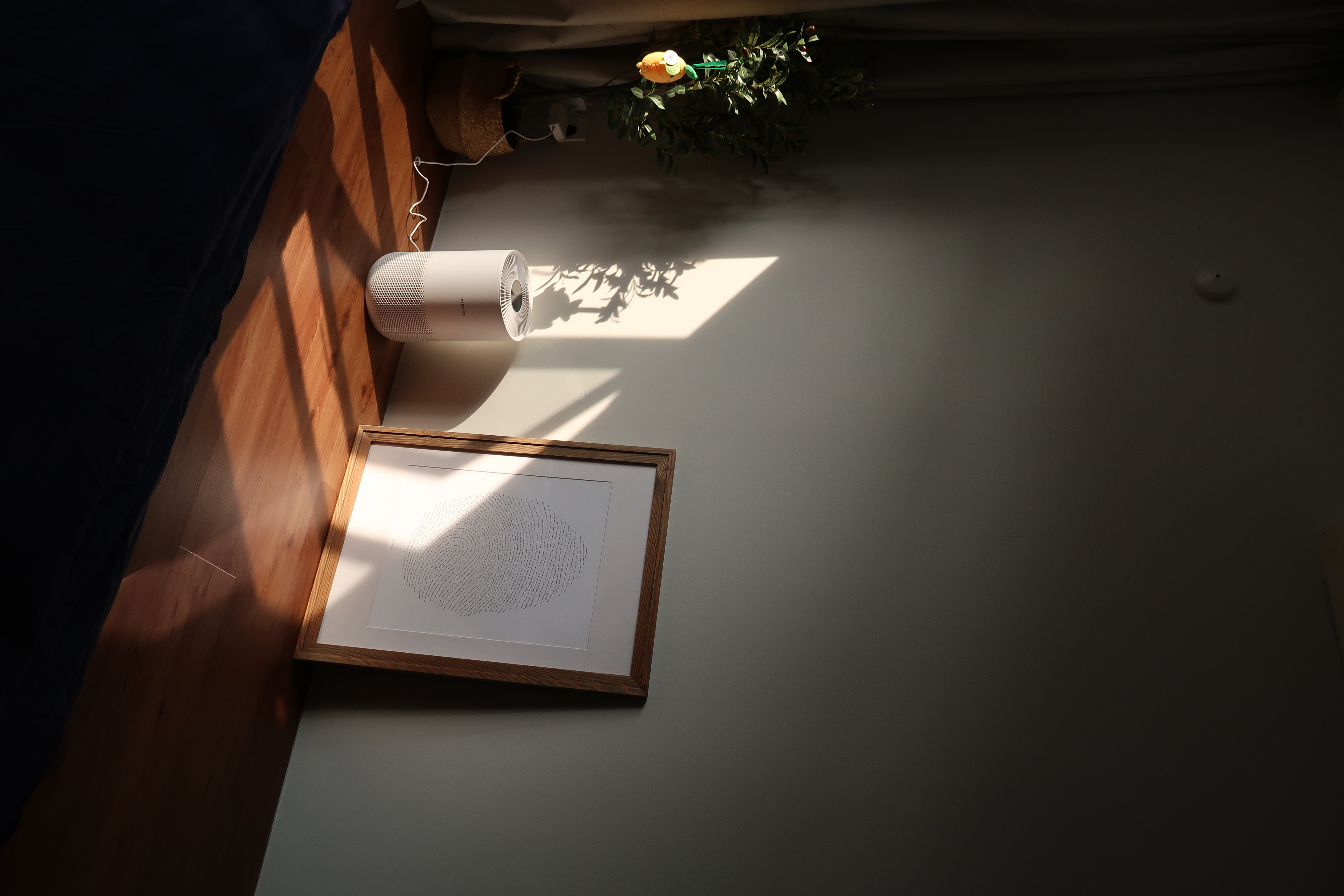 Unconventional bedroom styling - less than $1.2k for our bed - Sunlight streaming through window, dark blue bedspread, white