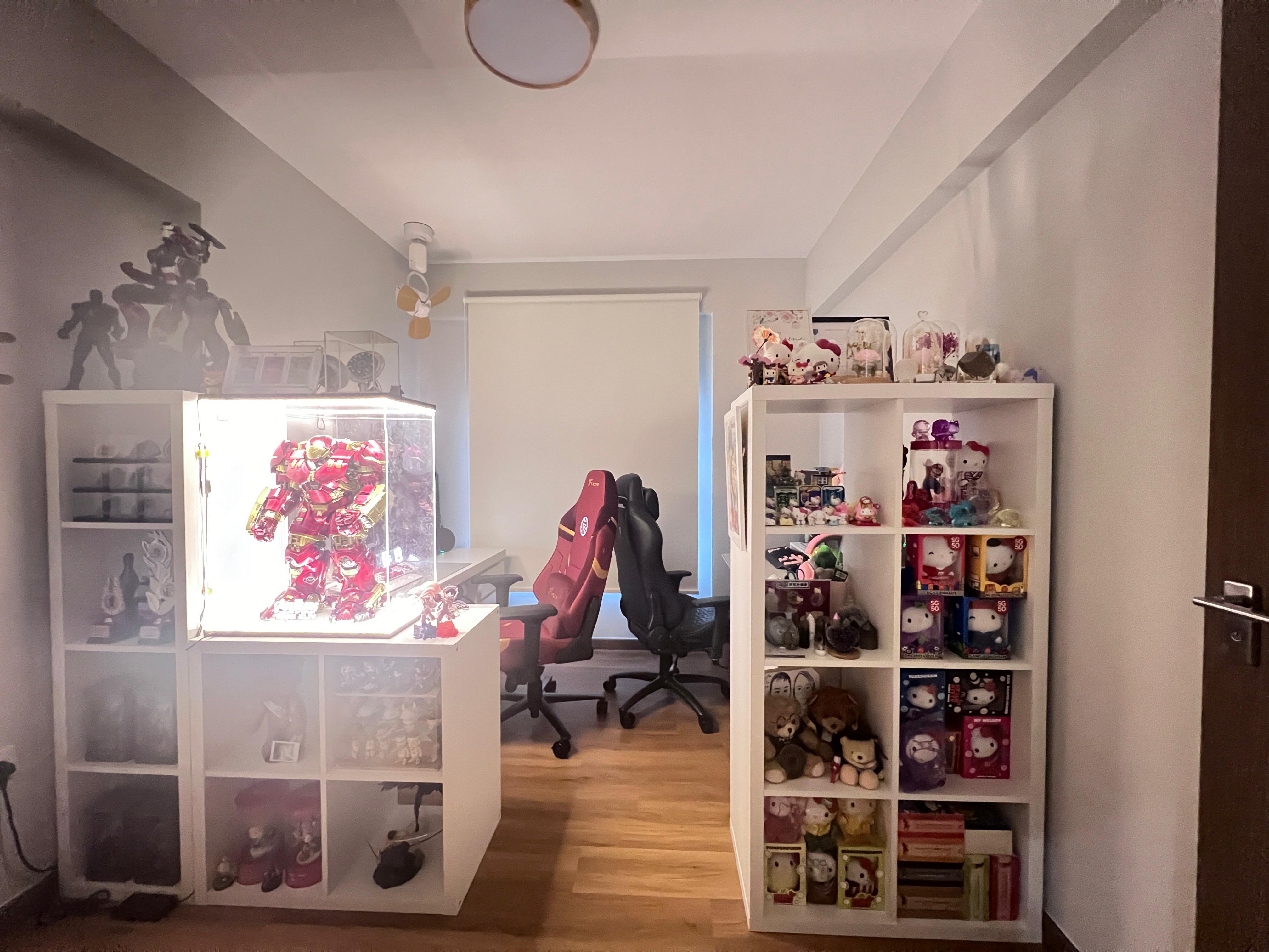 Self Design Work & Gaming Space - Red and gold robot model, white shelving unit, white ceiling fan, white wall, wooden floor