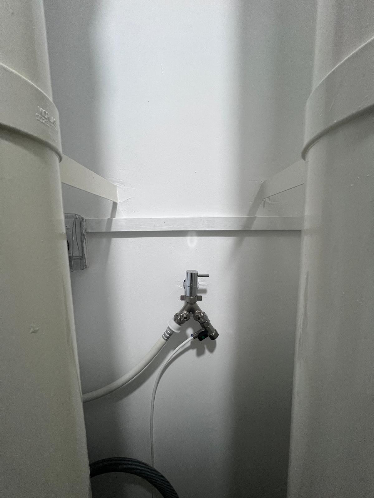 Service yard with zero built in! - Under-cabinet sink, plumbing fixtures, wall-mounted faucet, dual outlets, white PVC pipe