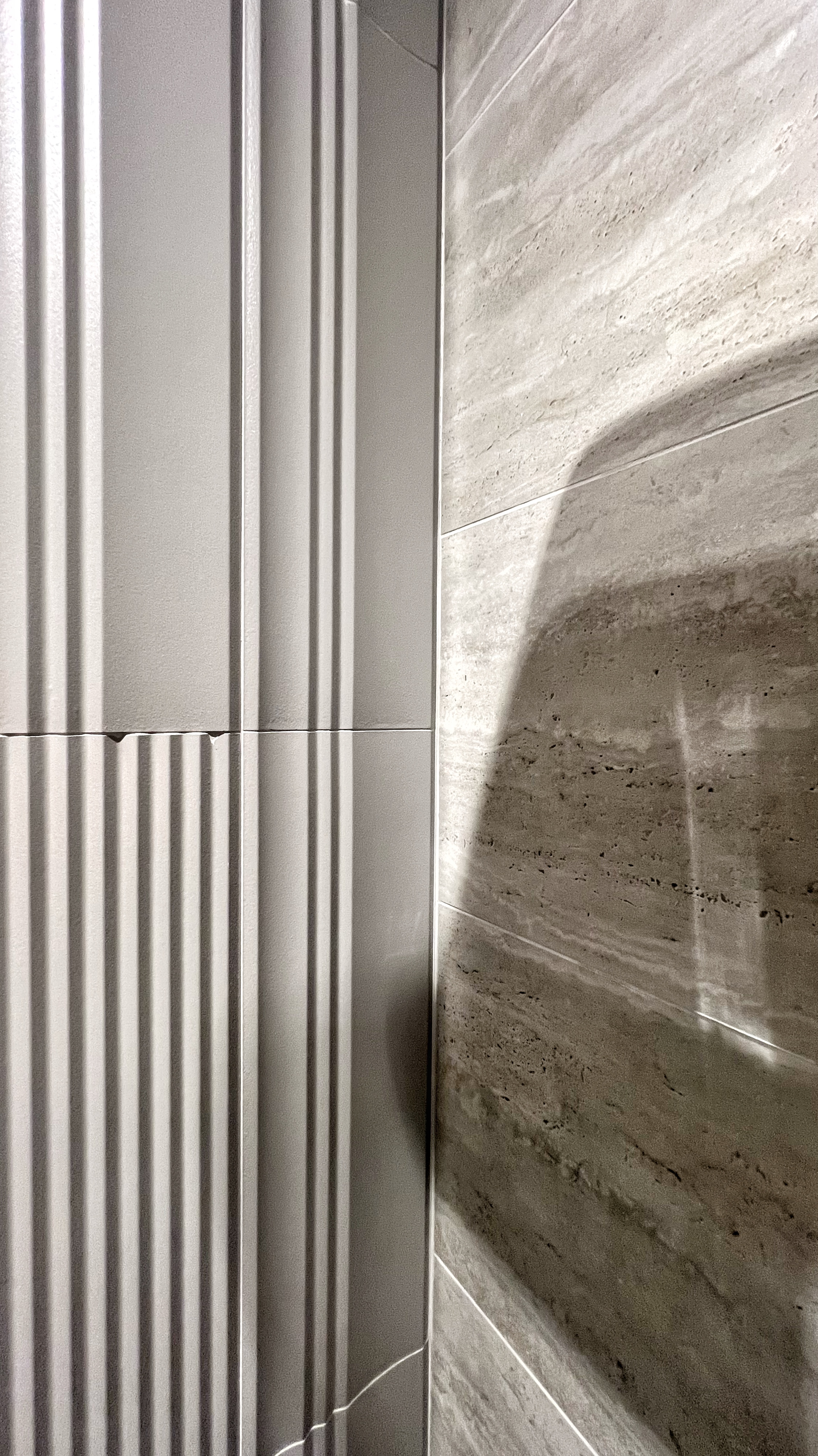 From Routine to Retreat: Crafting a Luxurious Bathroom Experience - Vertical concrete wall, modern design, textured surface