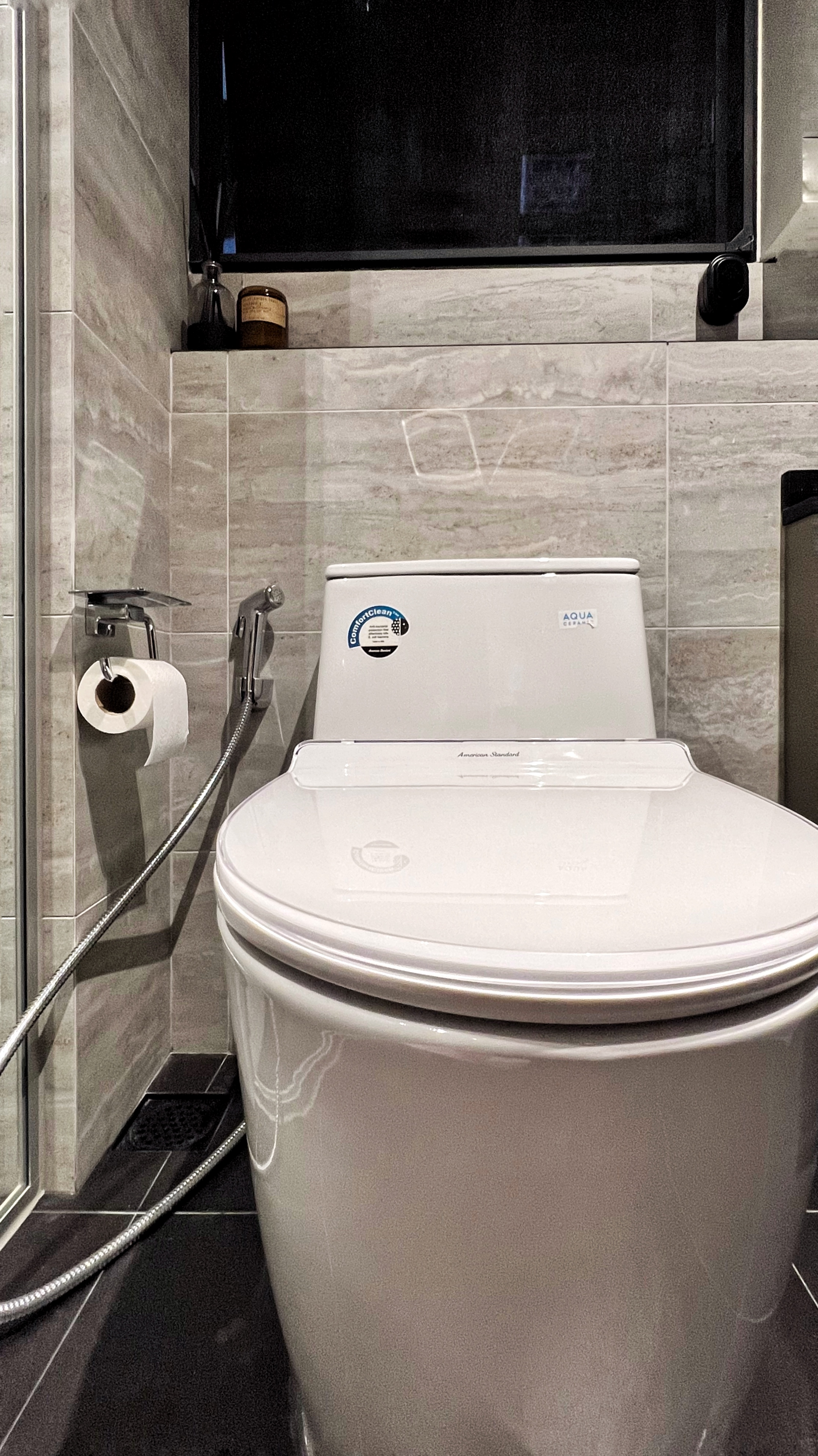 From Routine to Retreat: Crafting a Luxurious Bathroom Experience - White toilet with modern design, sleek black shower