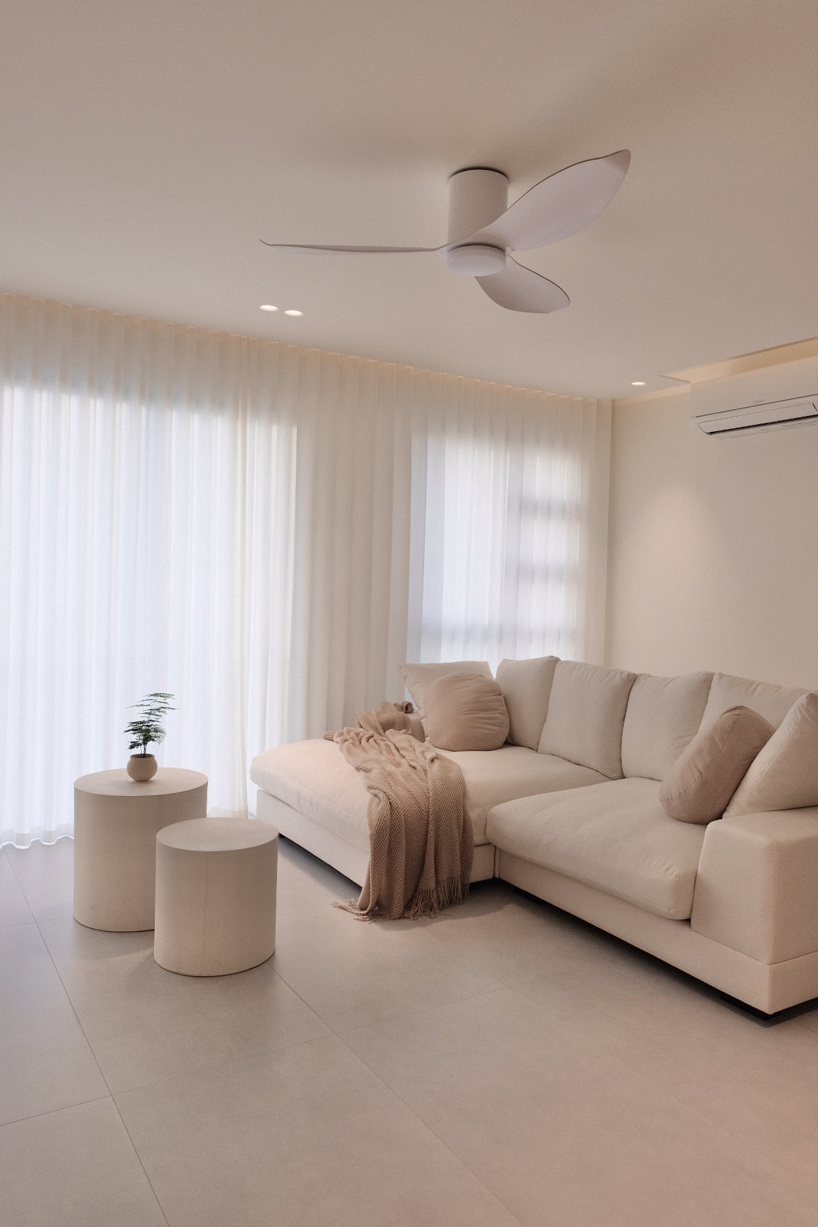 Our House Hunting Adventure - Modern minimalist living room, neutral color palette, large window with sheer curtains, beige