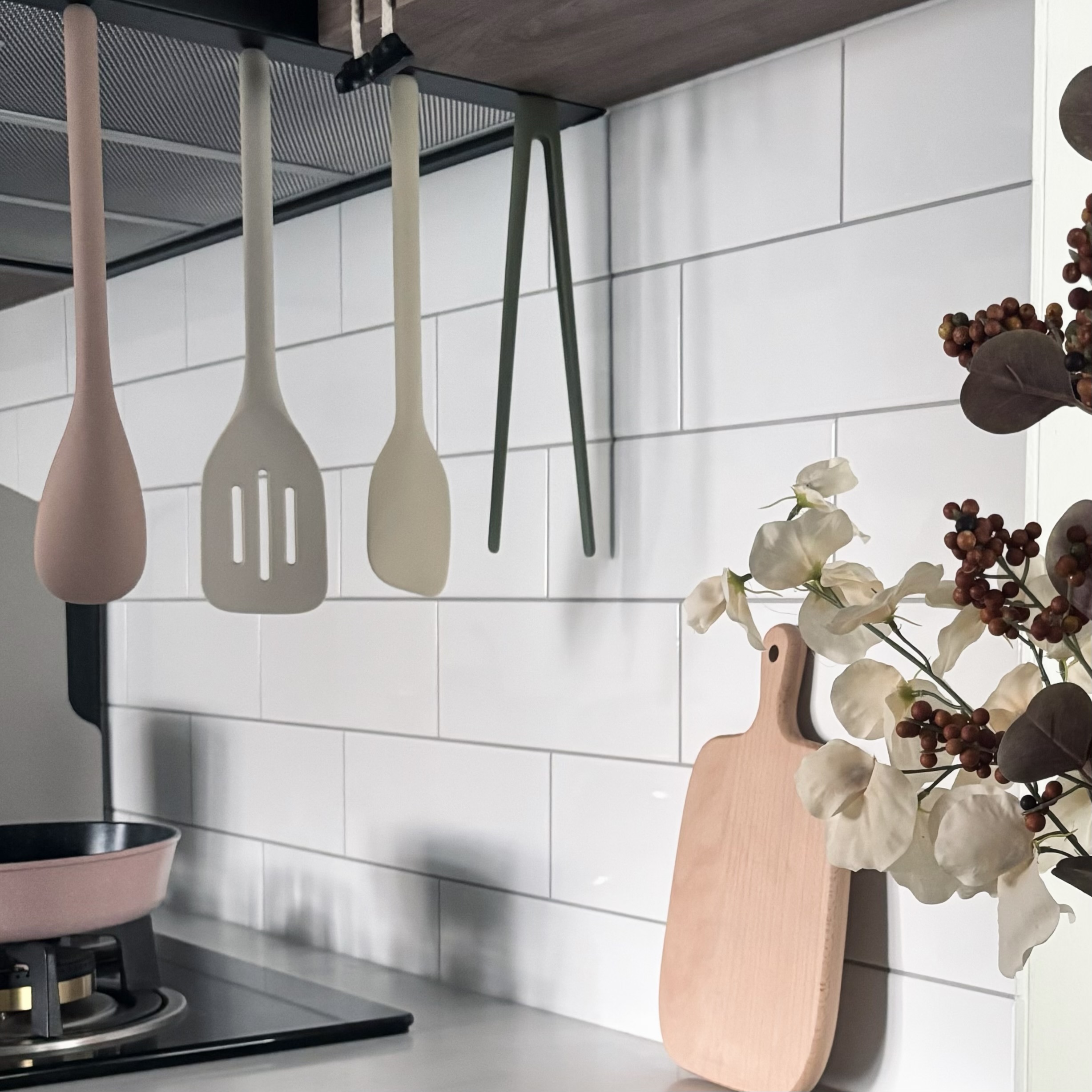 Easy ways to up your home aesthetic game! - pink ladle, white spatula, wooden cutting board, white flowers, kitchen utensils