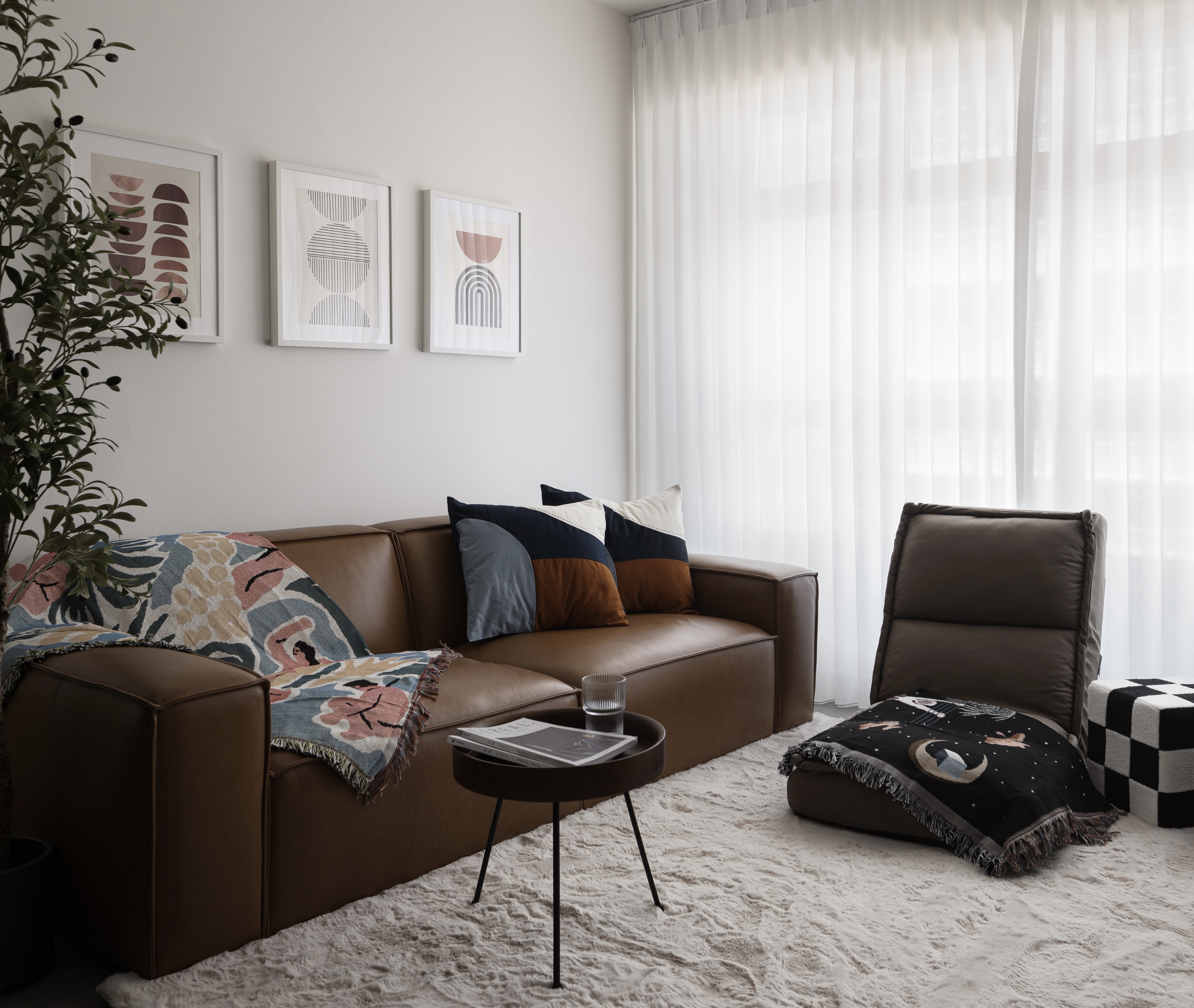 Easy ways to up your home aesthetic game! - Modern living room, cozy seating, brown leather sofa, abstract art, geometric