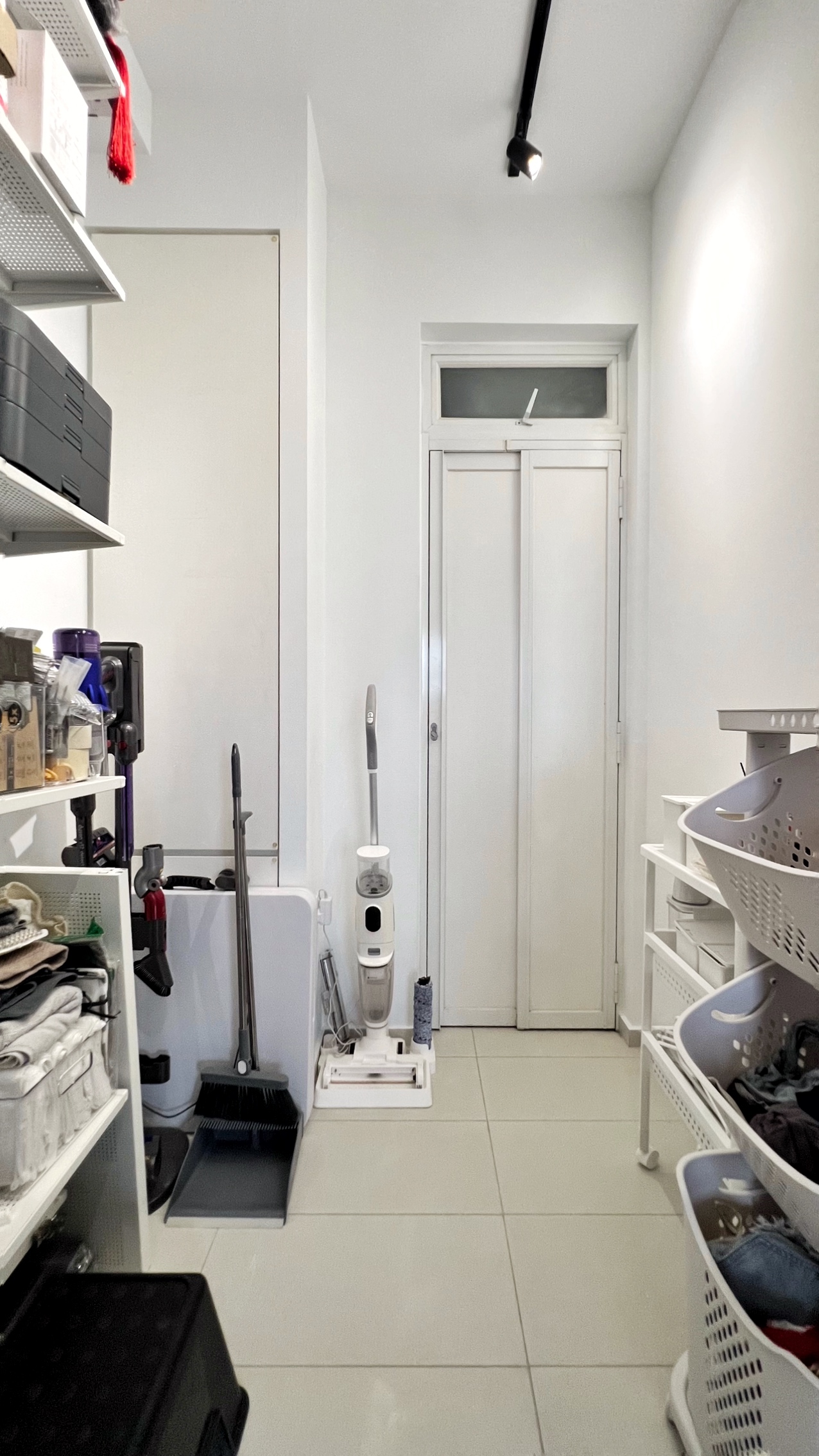 The Unsung Heroes: Where the Magic of Cleanliness Happens - Storage room, white walls, tiled floor, white door, shelves