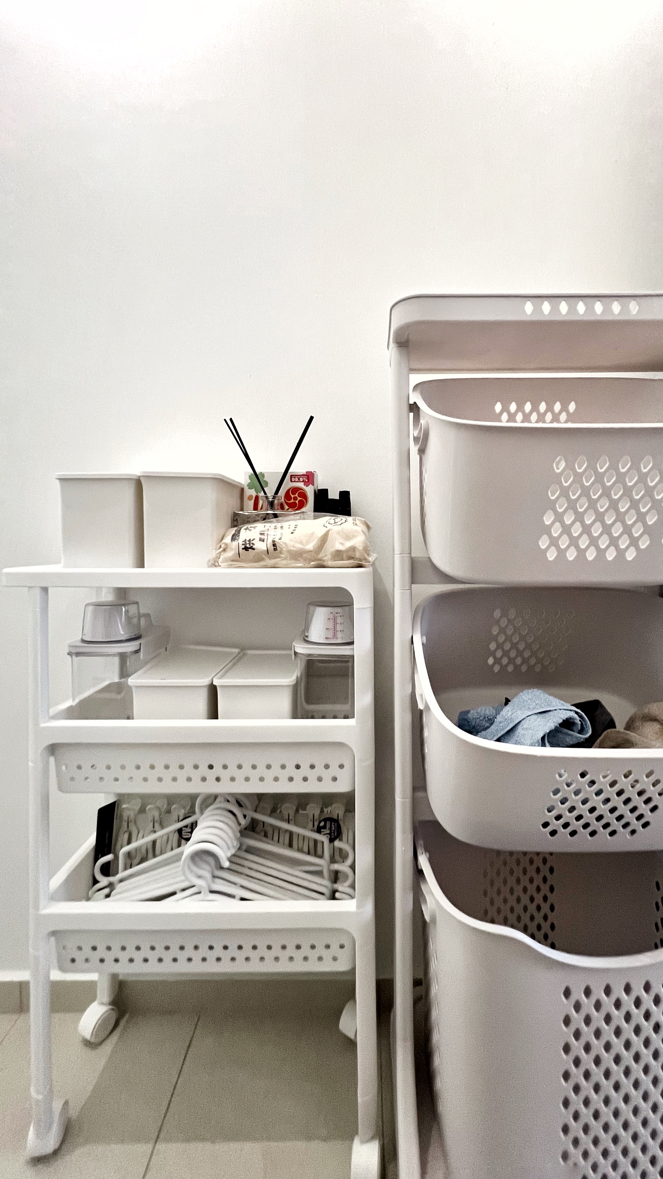 The Unsung Heroes: Where the Magic of Cleanliness Happens - white laundry basket, white shelf, white laundry