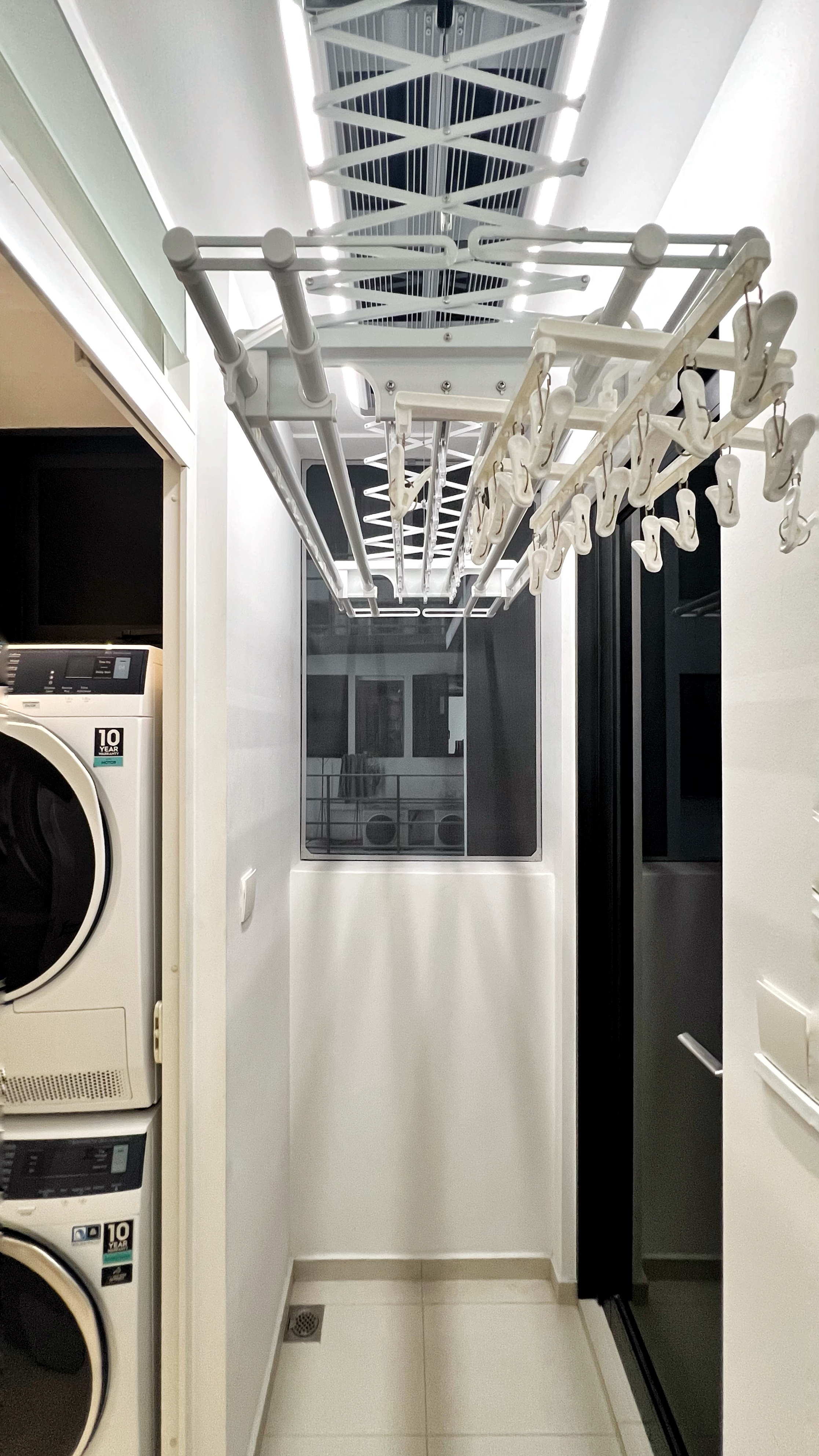 The Unsung Heroes: Where the Magic of Cleanliness Happens - Modern laundry room with sleek white fixtures, Wall-mounted