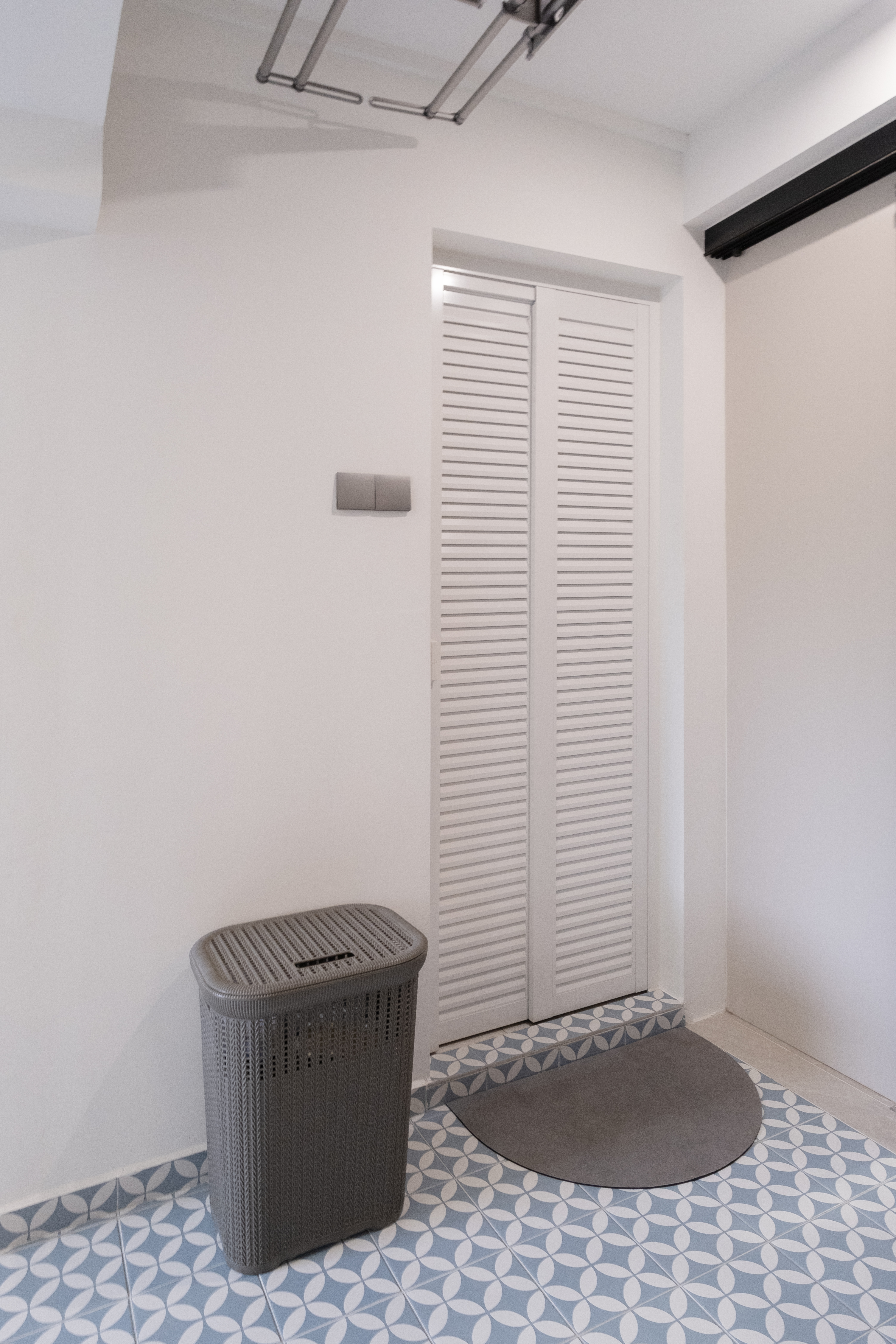 Old & Wet Kitchen No More: Meet our New Bright & Airy Service Yard - White louvered door, gray woven trash can, modern
